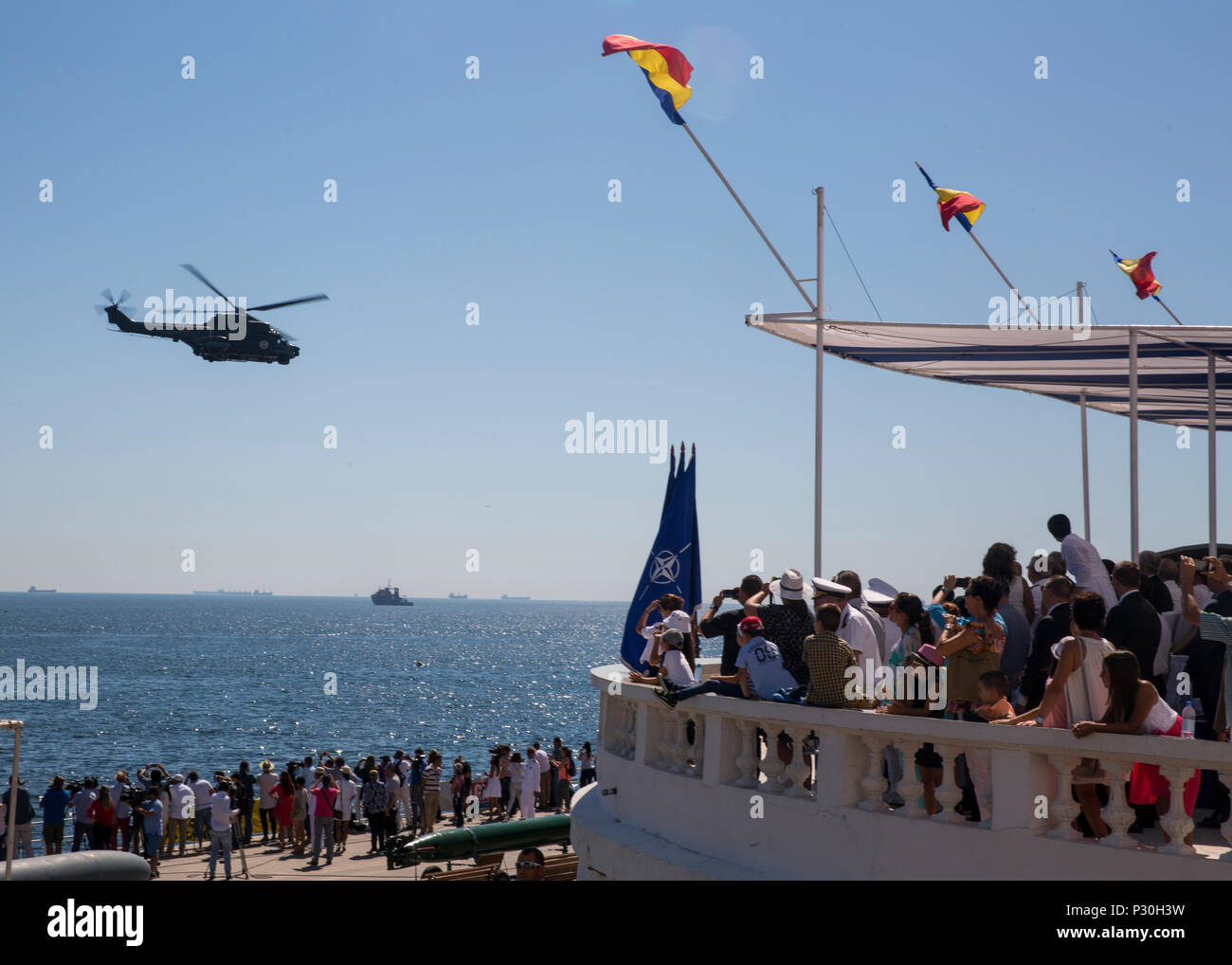 A Romanian helicopter delights a crowd of spectators during the 114th annual Navy Day celebration at the Port of Constanţa, Romania, Aug. 15, 2016. U.S. Sailors and Marines supporting the Black Sea Rotational Force 16.2 helped pay tribute to the prestigious history of the Romanian navy and highlighted the military’s movement toward new developments and modernizations. Black Sea Rotational Force is an annual multilateral security cooperation activity between the U.S. Marine Corps and partner nations in the Black Sea, Balkan and Caucasus regions designed to enhance participants’ collective profe Stock Photo