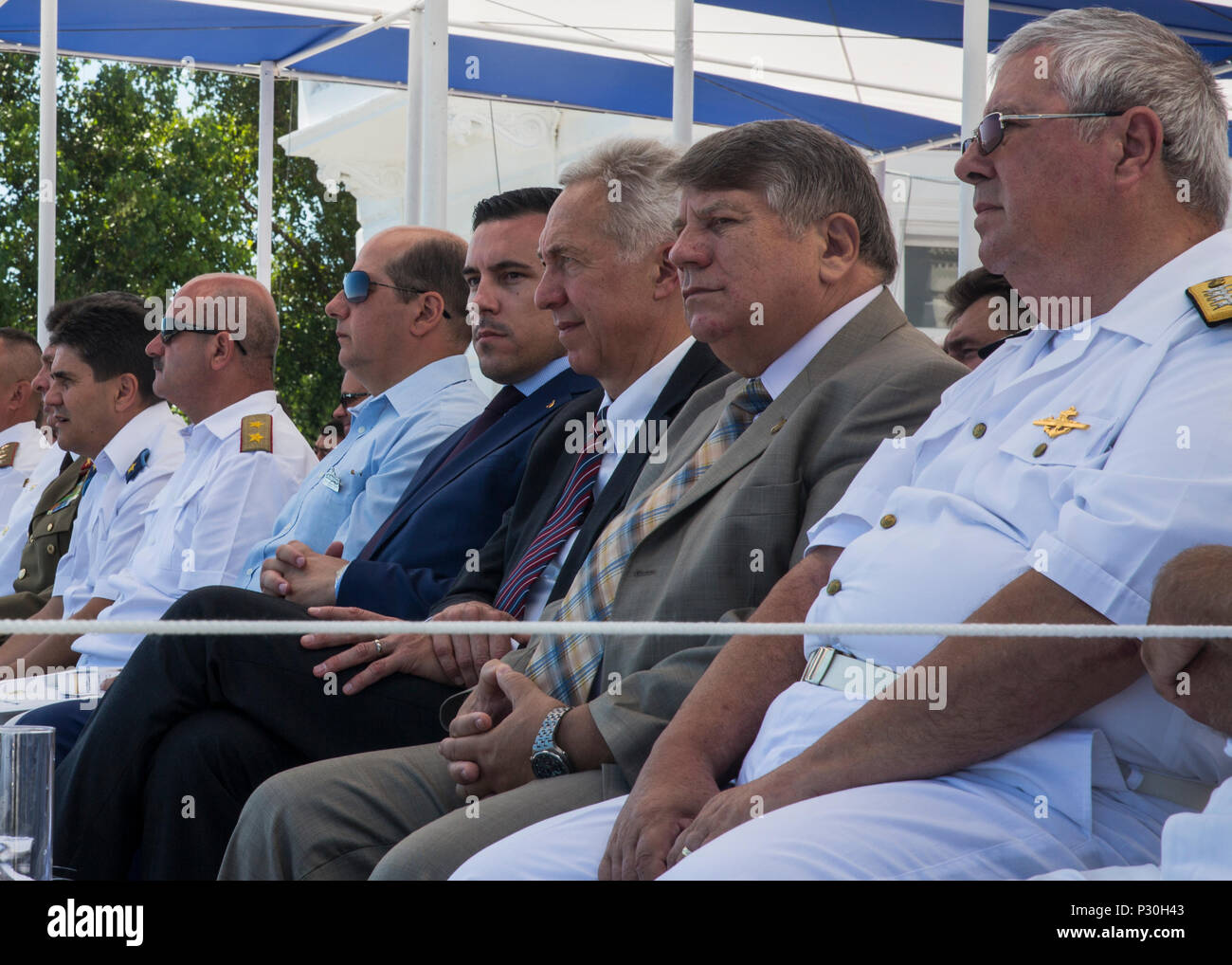 U.S. Ambassador to Romania Hans Klemm, third from the right, watches the festivities during the 114th annual Navy Day celebration at the Port of Constanţa, Romania, Aug. 15, 2016. U.S. Sailors and Marines supporting the Black Sea Rotational Force 16.2 helped pay tribute to the prestigious history of the Romanian navy and highlighted the military’s movement toward new developments and modernizations. Black Sea Rotational Force is an annual multilateral security cooperation activity between the U.S. Marine Corps and partner nations in the Black Sea, Balkan and Caucasus regions designed to enhanc Stock Photo
