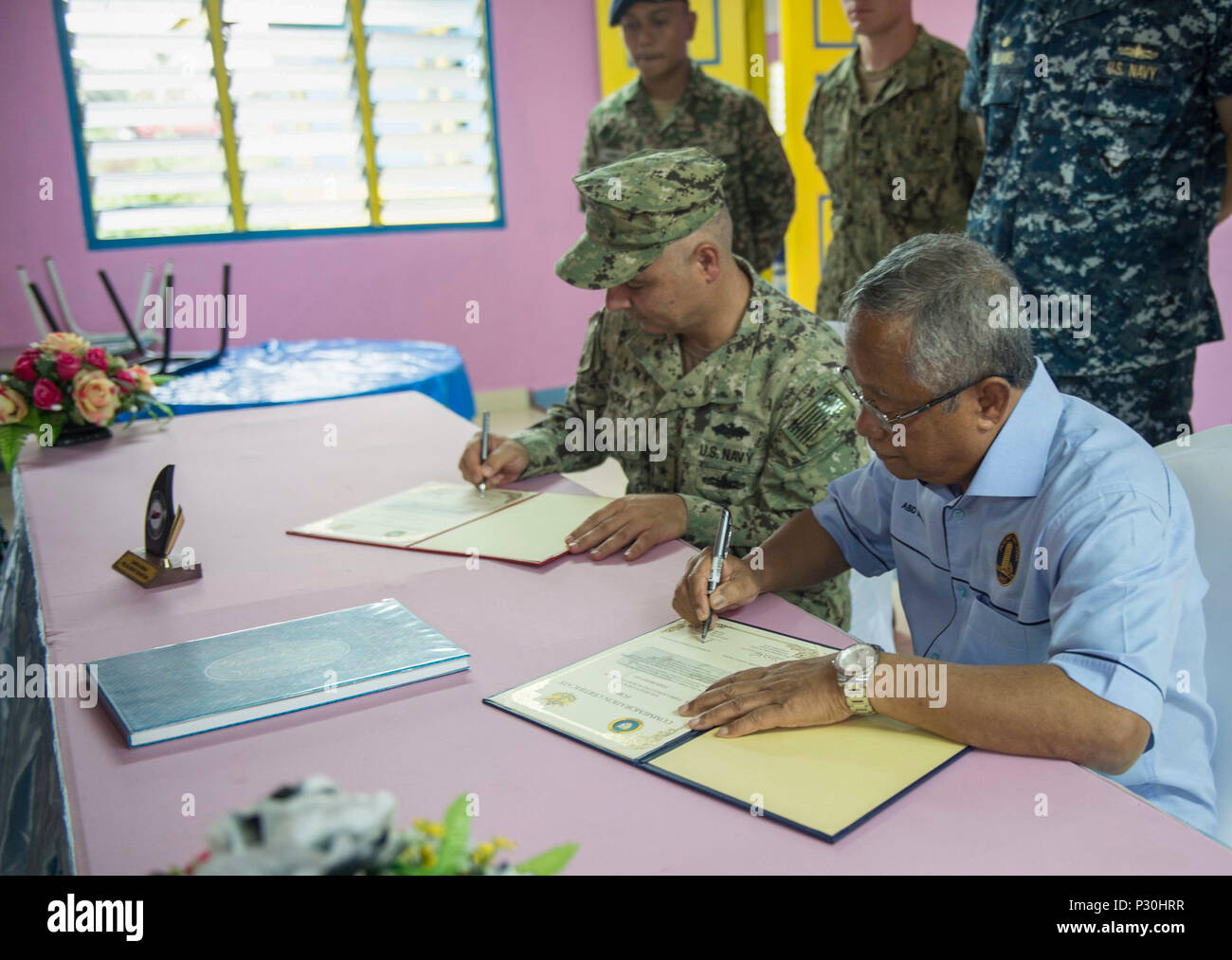 160812 N Sx983 474 Kuantan Malaysia Aug 12 2016 Rear Adm John W Korka Left Commander Naval Facilities Engineering Command Pacific And Haji Abdul Manan Bin Ismail Parliament Member Of Paya Besar Sign Commemoration Certificates