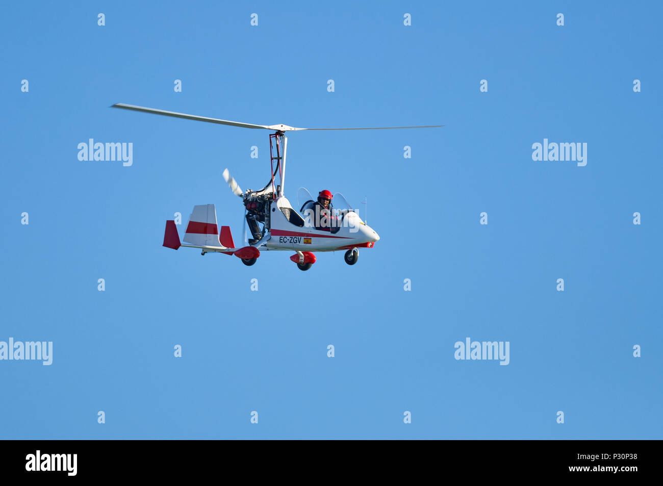 Magni Gyro M-16 Tandem Trainer two seat autogyro flying against a blue sky in Ses Salines Natural Park (Formentera, Balearic Islands, Spain) Stock Photo