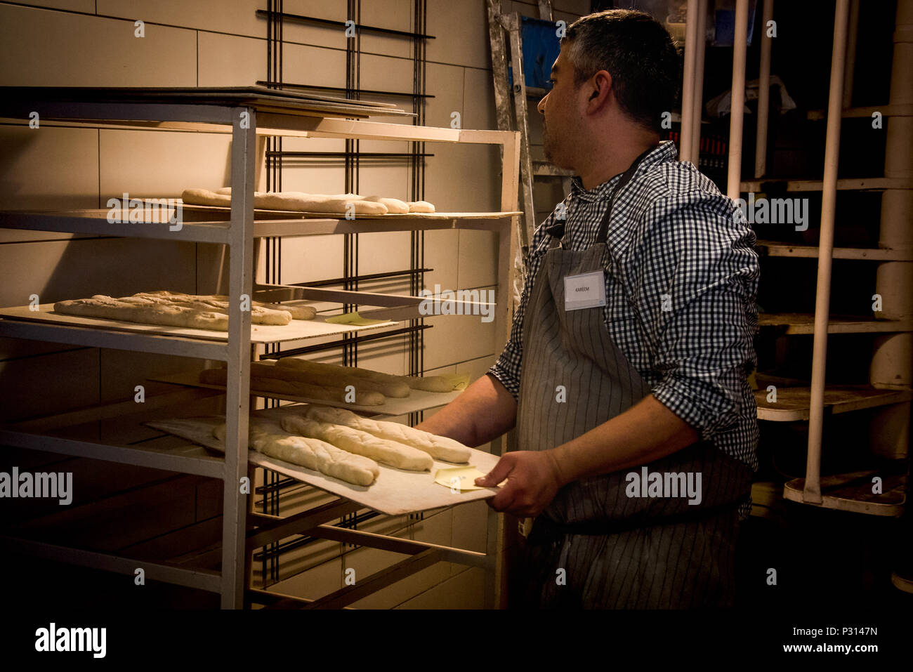 Baker, preparing bread loaf for baking Stock Photo