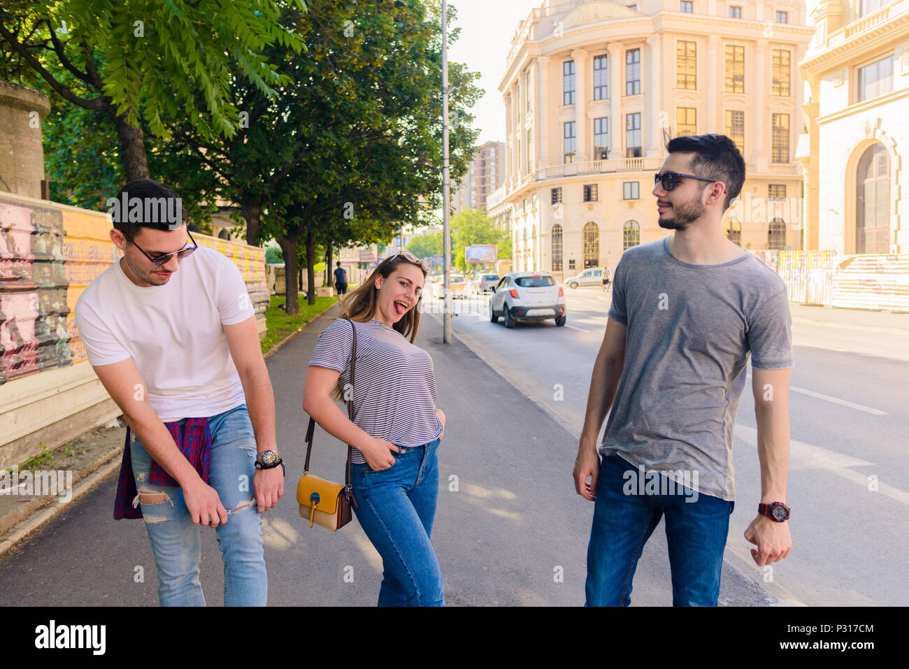 A group of young people walking down a street in a city Stock Photo - Alamy