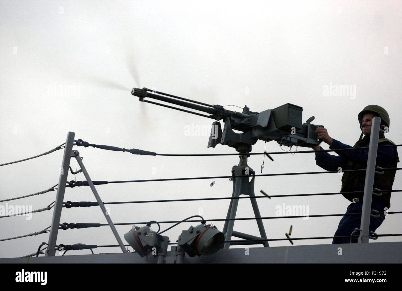 USS Winston S. Churchill (DDG 81)(Sep. 5, 2001) -- Gunner's Mate 2nd Class James Jensen mans a 50-caliber machine gun aboard the Churchill to deter terrorists, played by Royal Navy sailors, during Flag Officer Sea Training (FOST). The Norfolk, Va., based destroyer is the first American vessel to attend FOST, a tailored and integrated training program facilitated by the Royal Navy similar to the Stock Photo
