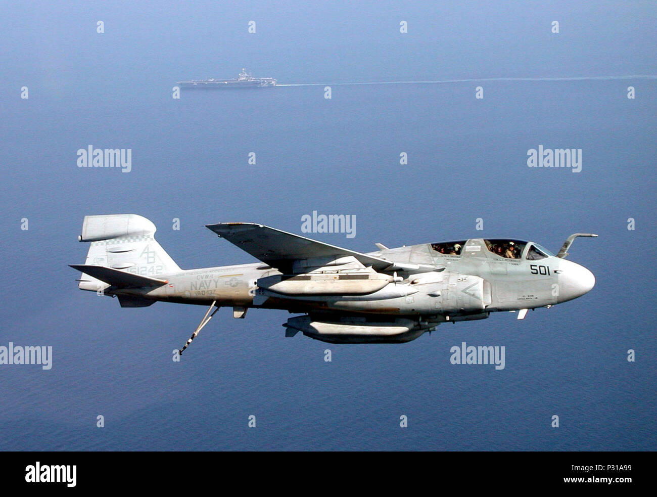 the Arabian Sea (Dec. 4, 2001) -- An EA-6B Prowler from the 'Rooks' of Tactical Electronic Warfare Squadron One Three Seven (VAQ-137) circles USS Theodore Roosevelt (CVN 71) for its final approach.  The 'Rooks' are part of Carrier Air Wing One (CVW-1) deployed on the nuclear aircraft carrier in support of Operation Enduring Freedom. Stock Photo