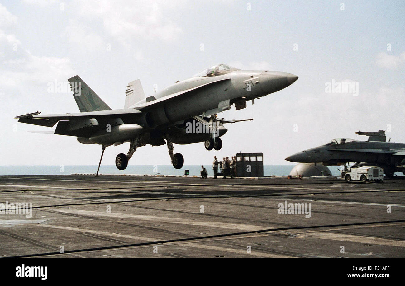 sea aboard USS Theodore Roosevelt  (CVN 71) Dec. 18, 2001 -- An F/A-18 Hornet from the 'Marauders' of Strike Fighter Squadron Eight Two (VFA-82) lands on the flight deck  USS Theodore Roosevelt.  The squadron is part of Carrier Air Wing One (CVW-1) deployed on the nuclear powered aircraft carrier in support of Operation Enduring Freedom. Stock Photo