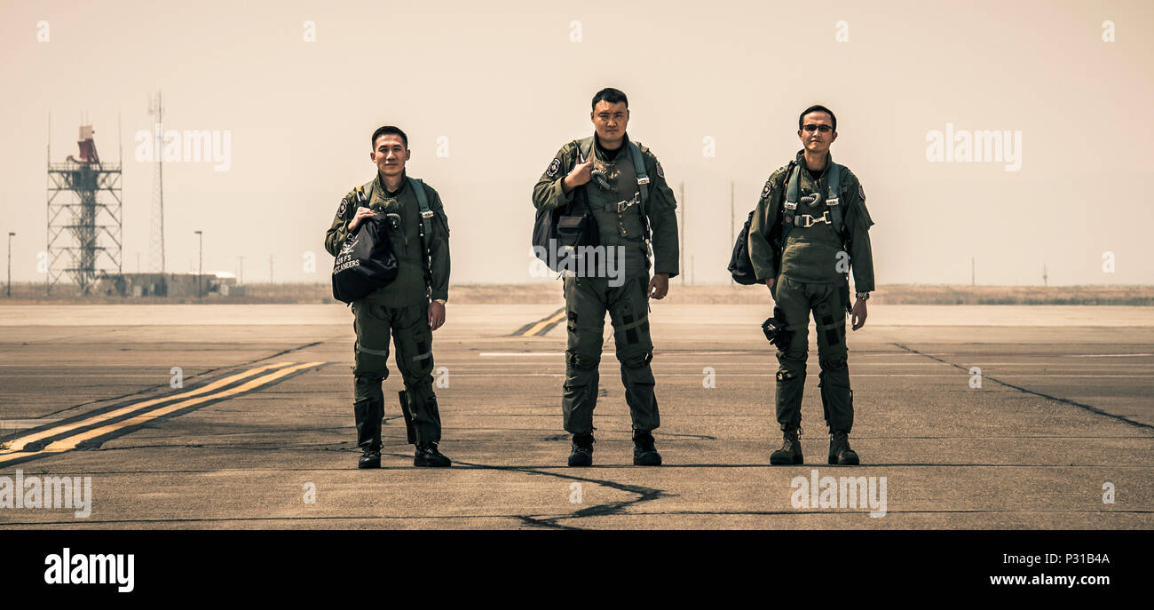 From the left, Republic of Singapore Air Force Weapons Systems Officers Capt. Alex Ong and Capt. Chia Chi Yu and F-15SG Pilot Maj. Wang Kee Yong stand on the flightline at Mountain Home Air Force Base, Idaho. The three are the first to graduate the RSAF Fighter Weapons Instructor Course, modeled after the U.S. Air Force Fighter Weapons School program. (U.S. Air Force photo by Senior Airman Lauren-Taylor Levin) Stock Photo