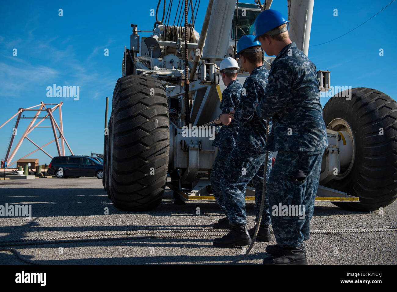 160822-N-FV405-187 NORFOLK, Va. (Aug. 22, 2016) Sailors steady tending lines in preparation to move the mobile crash crane during its offload from aircraft carrier USS Harry S. Truman (CVN 75). Truman recently returned to its homeport at Naval Station Norfolk, completing an 8-month deployment to the U.S. 5th and 6th Fleet areas of operations. (U.S. Navy photo by Mass Communication Specialist Seaman Victoria Granado/Released) Stock Photo