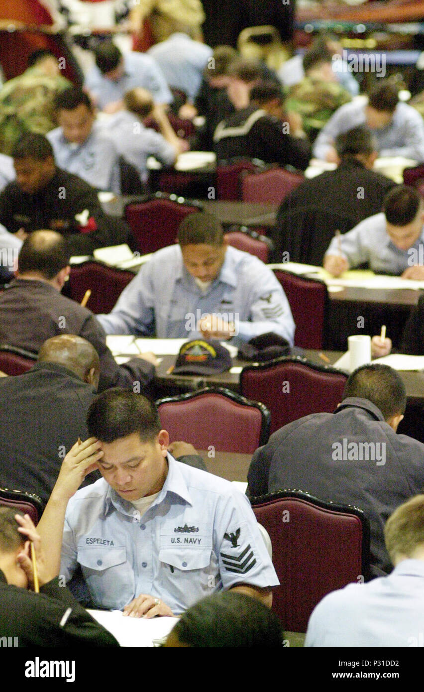 Japan (Jan. 17, 2002) -- Mess Specialist 1st Class from Bataan, Republic of the Philippines, participates in the annual exam for advancement to Chief Petty Officer, held today at 'Club Trilogy' aboard the Naval Air Facility in Atsugi, Japan.  The exam contained 50 additional questions than in previous years. 100 questions pertain to professional development and 100 questions address military leadership.  Each sailor has three hours to complete the exam. Stock Photo