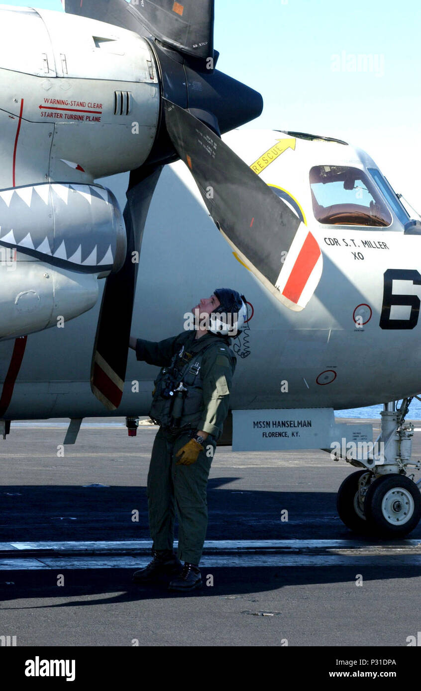 USS Theodore Roosevelt (CVN 71) Jan. 21, 2002 -- A pilot checks the propellers of an E-2C 'Hawkeye' from the 'Screwtops' of Carrier Airborne Early Warning Squadron One Two Three (VAW-123).  The Screwtops are part of Carrier Air Wing One (CVW 1) currently deployed with USS Theodore Roosevelt (CVN 71) in support of Operation Enduring Freedom. Stock Photo