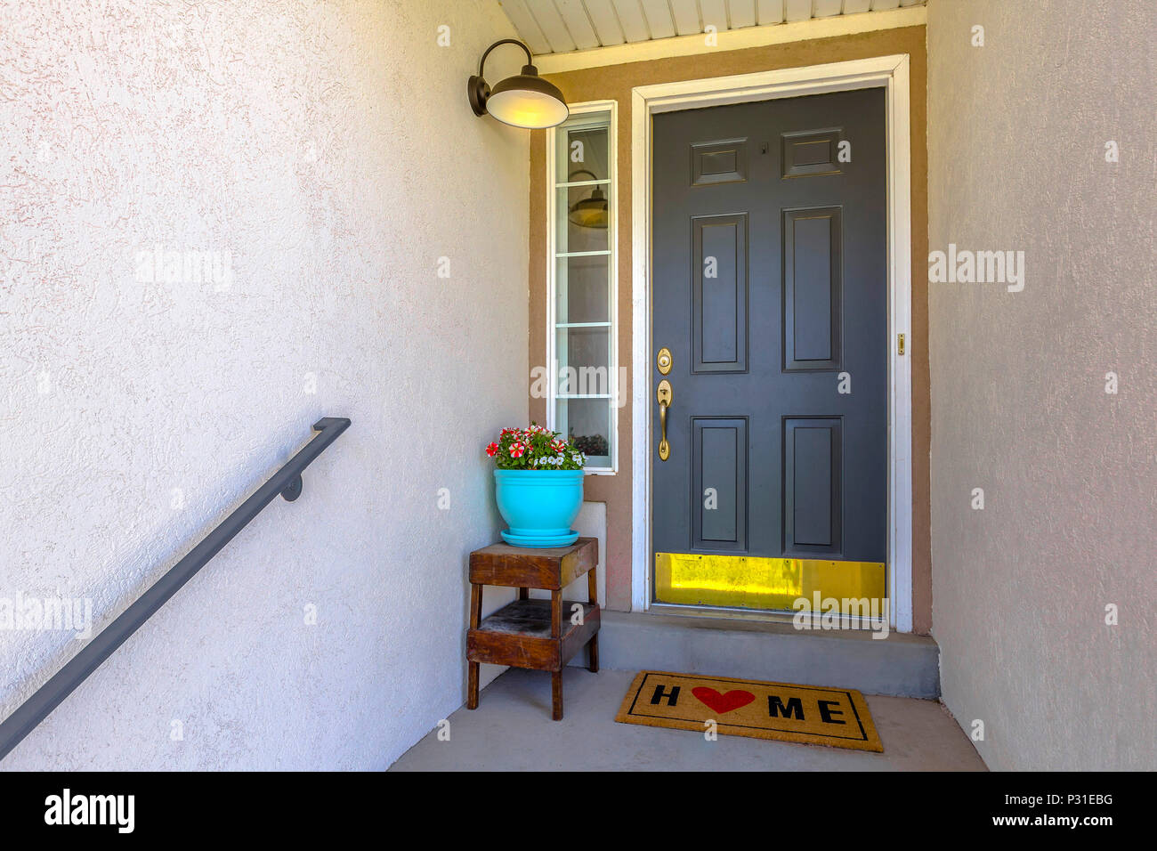 Front door in Lehi Utah with potted plant and flowers and a floor mat