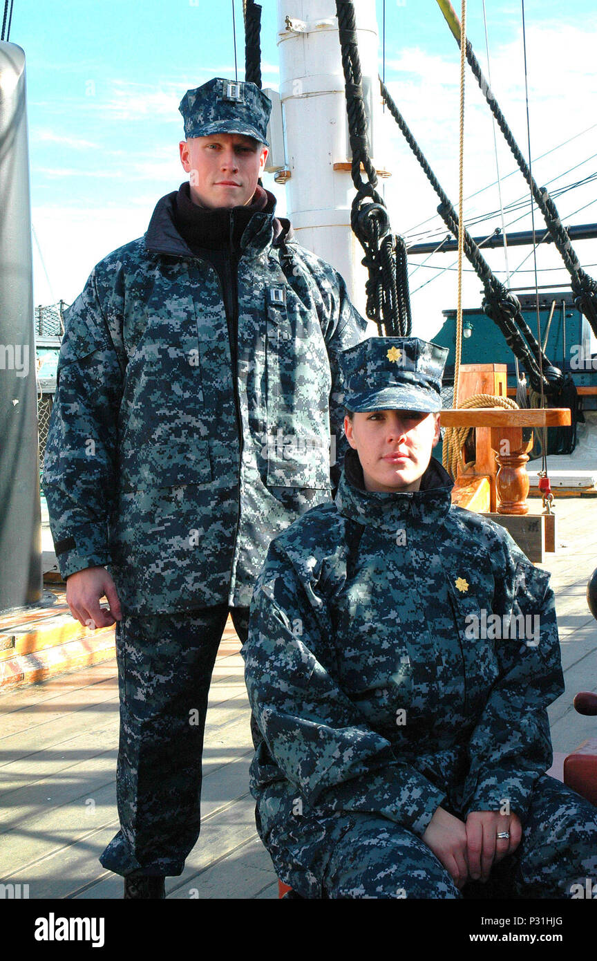 Two sailors pose aboard USS Constitution wearing blue digital pattern battle dress uniform concept Stock Photo