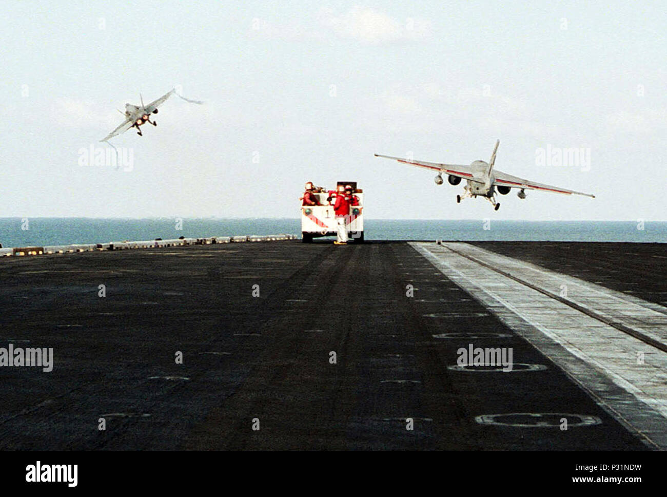 sea aboard USS Theodore Roosevelt (CVN 71) Dec. 18, 2001 -- Sailors from crash and salvage standby as an F/A-18 Hornet and an S-3B Viking launch from the flight deck of the nuclear powered aircraft carrier.  The aircraft are part of Carrier Air Wing One (CVW-1) deployed on USS Theodore Roosevelt supporting Operation Enduring Freedom. Stock Photo