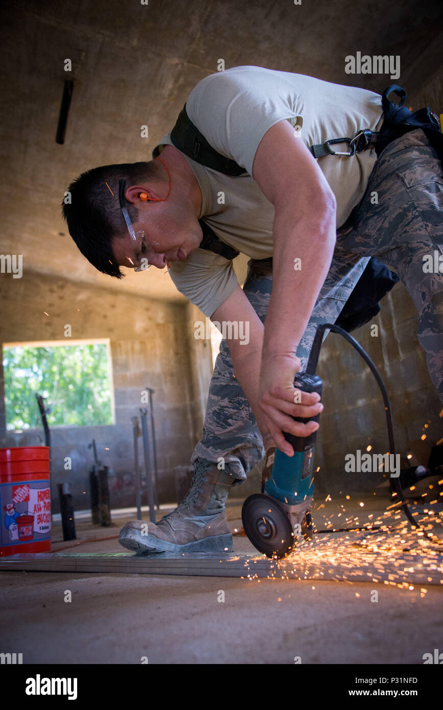 MALOJLOJ, Guam -- Staff Sgt. Nathaniel Boehlke, a structures journeyman with the 134th Air Refueling Wing Civil Engineering squadron, cuts a metal stud to prepare for interior framing of a home.  The Airmen are working on two Habitat for Humanity homes in Guam as part of a government initiative that allows military assets the opportunity to assist non-profit organizations in conjunction with scheduled annual training. (Air National Guard photo by Tech. Sgt. Jonathan Young) Stock Photo