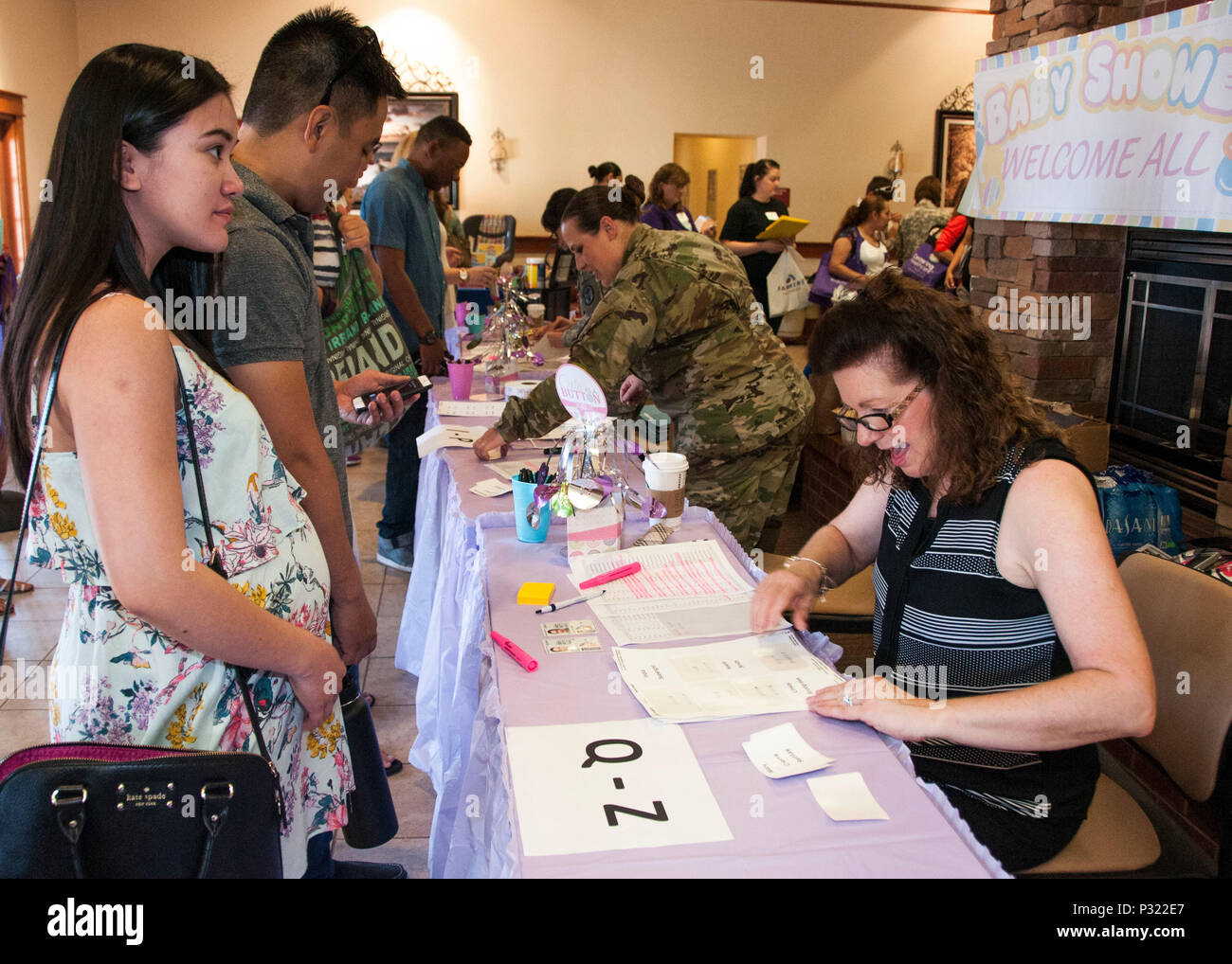 Kim Hall (right), head nurse, OB-GYN, William Beaumont Army Medical Center, checks in Spc. Ereene Sy, 3rd Brigade Combat Team, 1st Armored Division, during the 3rd annual installation-wide baby shower for expecting moms at Fort Bliss' Family Resilience Center, Aug. 19. The baby shower welcomed over 150 expecting moms and spouses to display support from local organizations while engaging the participants in a day of educational material regarding pregnancy, childbirth, breastfeeding and nutrition. Stock Photo