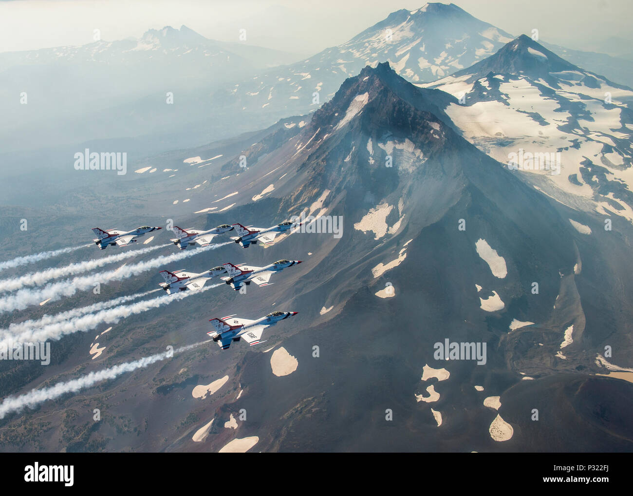 The Thunderbirds pilots fly over Three Sisters volcanic peaks in Oregon during their return to Nellis Air Force Base, Nev., August 29, 2016. The Thunderbirds performed at the Airshow and Warrior Expo at Joint Base Lewis-McChord, Wash., August 27-28. (U.S. Air Force photo/Tech. Sgt. Christopher Boitz) Stock Photo