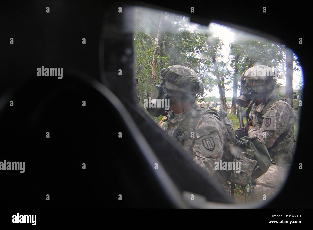 U.S. Army Reserve Soldiers assigned to the 327th Engineer Company, 397th Engineer Battalion, 372nd Engineer Brigade, 416th Theater Support Command, donned their pro masks in a complex attack that included 'chemical' warfare during Combat Support Training Exercise 86-16-03 (CSTX 86-16-03) on Fort McCoy, Wis., Aug. 22, 2016. Nearly 9,000 service members from across the country are participating in CSTX 86-16-03 hosted by the 86th Training Division and the 84th Training Command’s third and final CSTX of the year. (U.S. Army Reserve Photo by Sgt. 1st Class Clinton Wood). Stock Photo