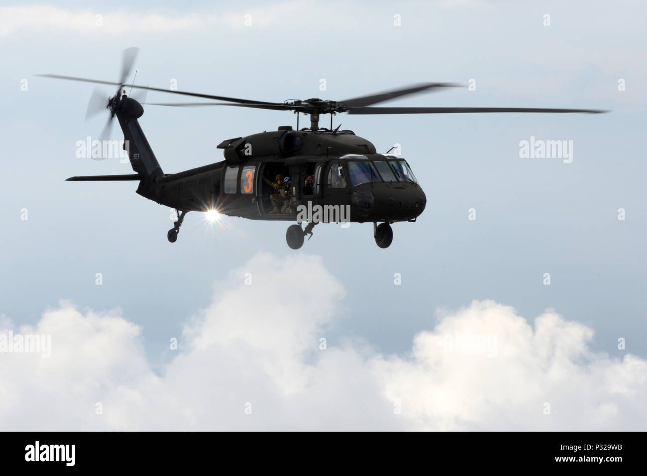 A U.s. Army Sikorsky Uh-60 Black Hawk Helicopter Flies Above A Drop 