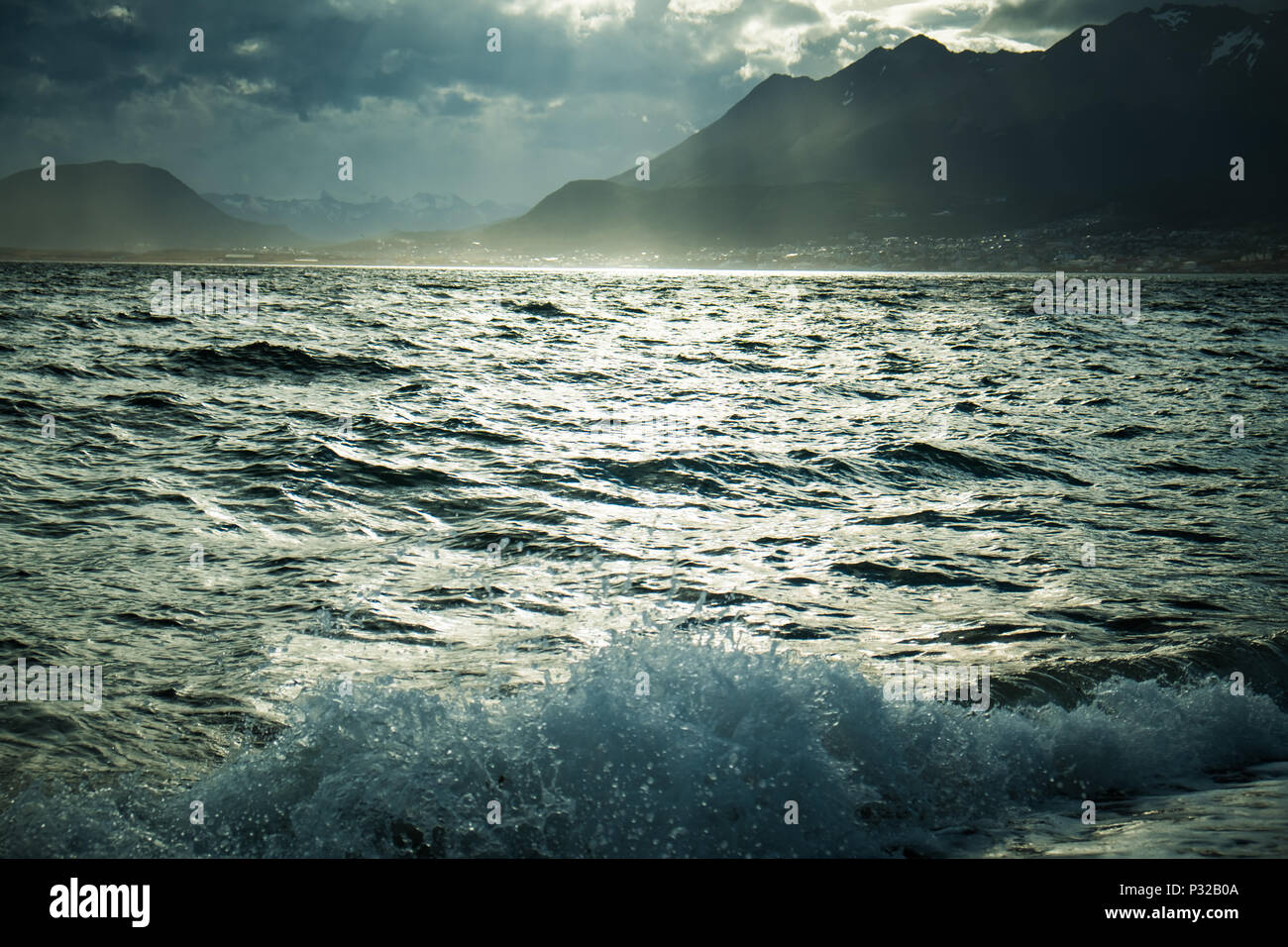 A wave of the Beagle Channel crashes on Playa Larga, a popular day trip to the outskirts of Ushuaia, soutern Argentina. Stock Photo