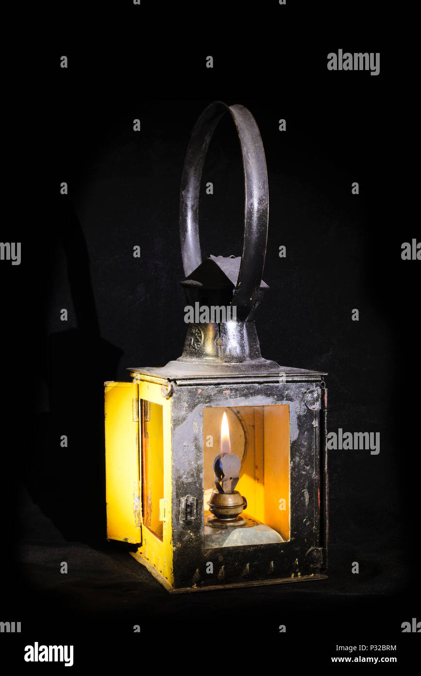 Old railroad petrol lantern with fire inside Stock Photo