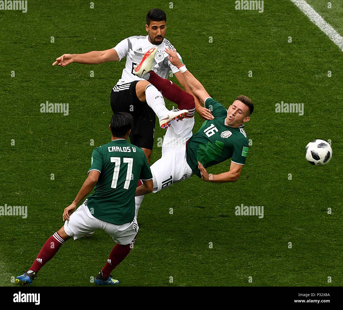Moscow, Russia. 17th June, 2018. Sami Khedira (top) of Germany vies with Hector Herrera (R) of Mexico during a group F match between Germany and Mexico at the 2018 FIFA World Cup in Moscow, Russia, June 17, 2018. Credit: Wang Yuguo/Xinhua/Alamy Live News Stock Photo
