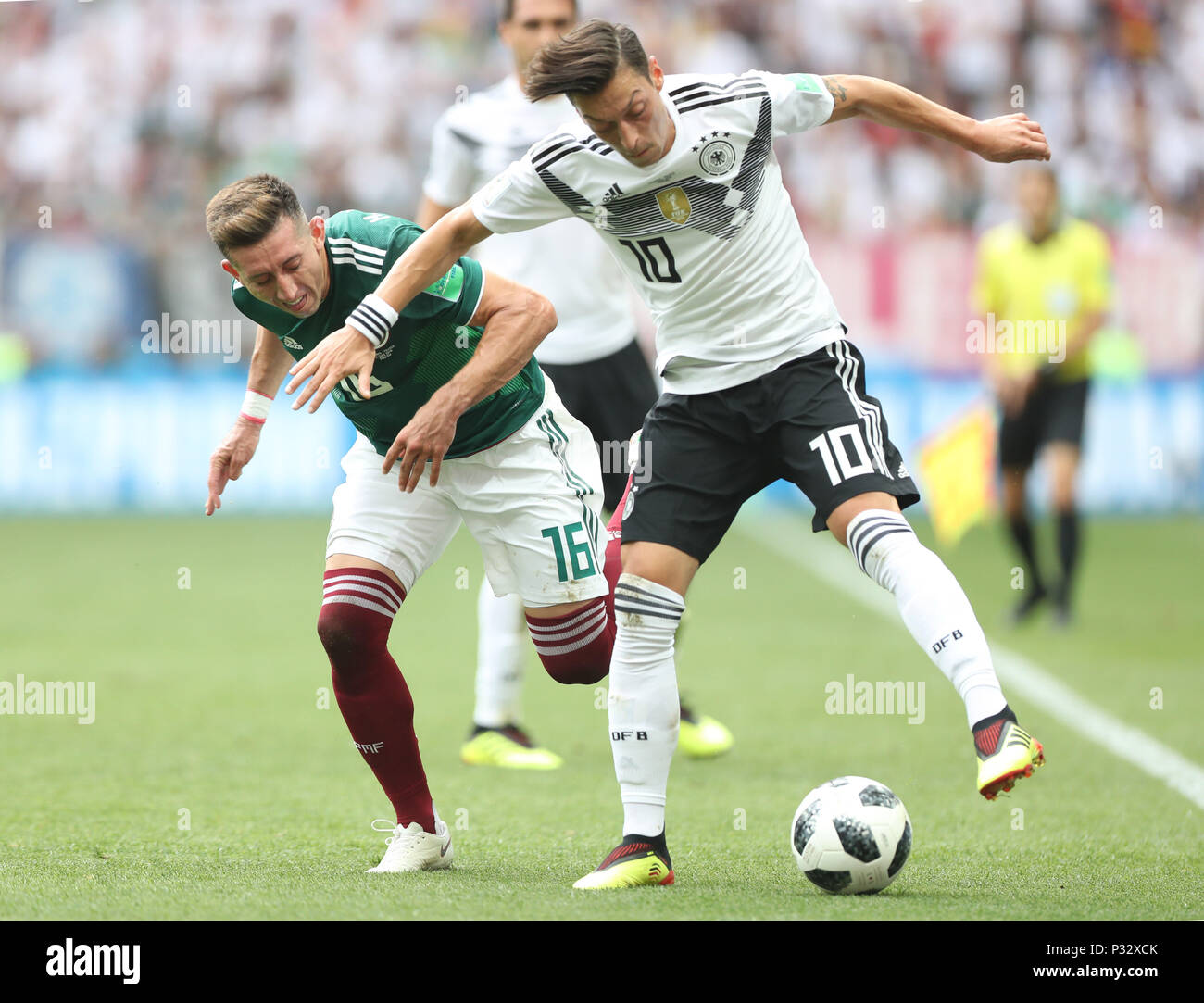 Moscow, Russia. 17th June, 2018. Mesut Oezil (R) of Germany vies with Hector Herrera of Mexico during a group F match between Germany and Mexico at the 2018 FIFA World Cup in Moscow, Russia, June 17, 2018. Credit: Xu Zijian/Xinhua/Alamy Live News Stock Photo