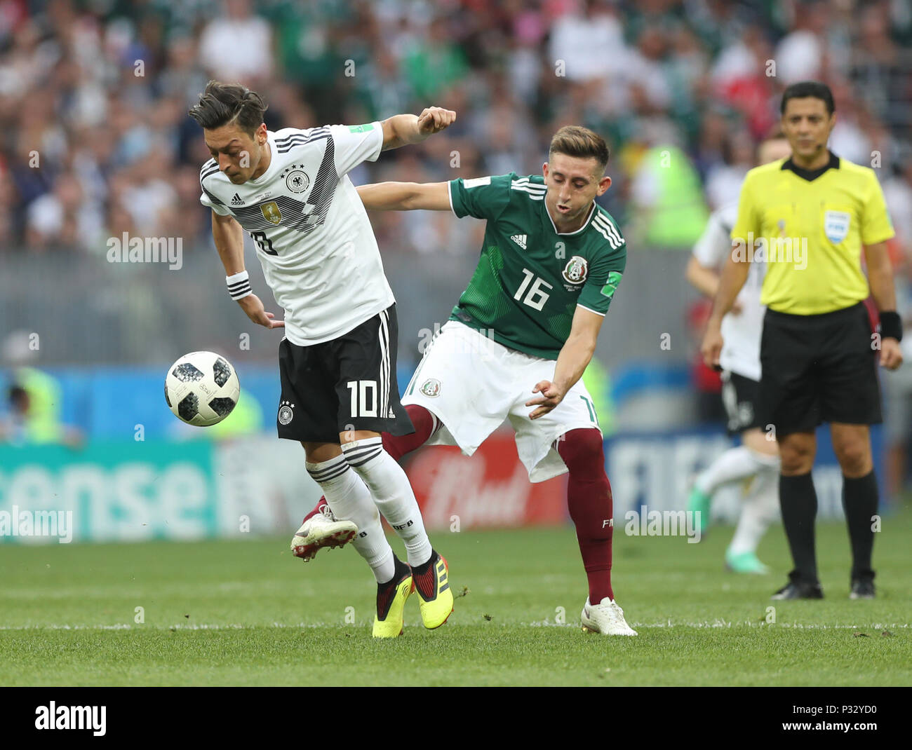 Moscow, Russia. 17th June, 2018. Mesut Oezil (L) of Germany vies with Hector Herrera of Mexico during a group F match between Germany and Mexico at the 2018 FIFA World Cup in Moscow, Russia, June 17, 2018. Credit: Xu Zijian/Xinhua/Alamy Live News Stock Photo