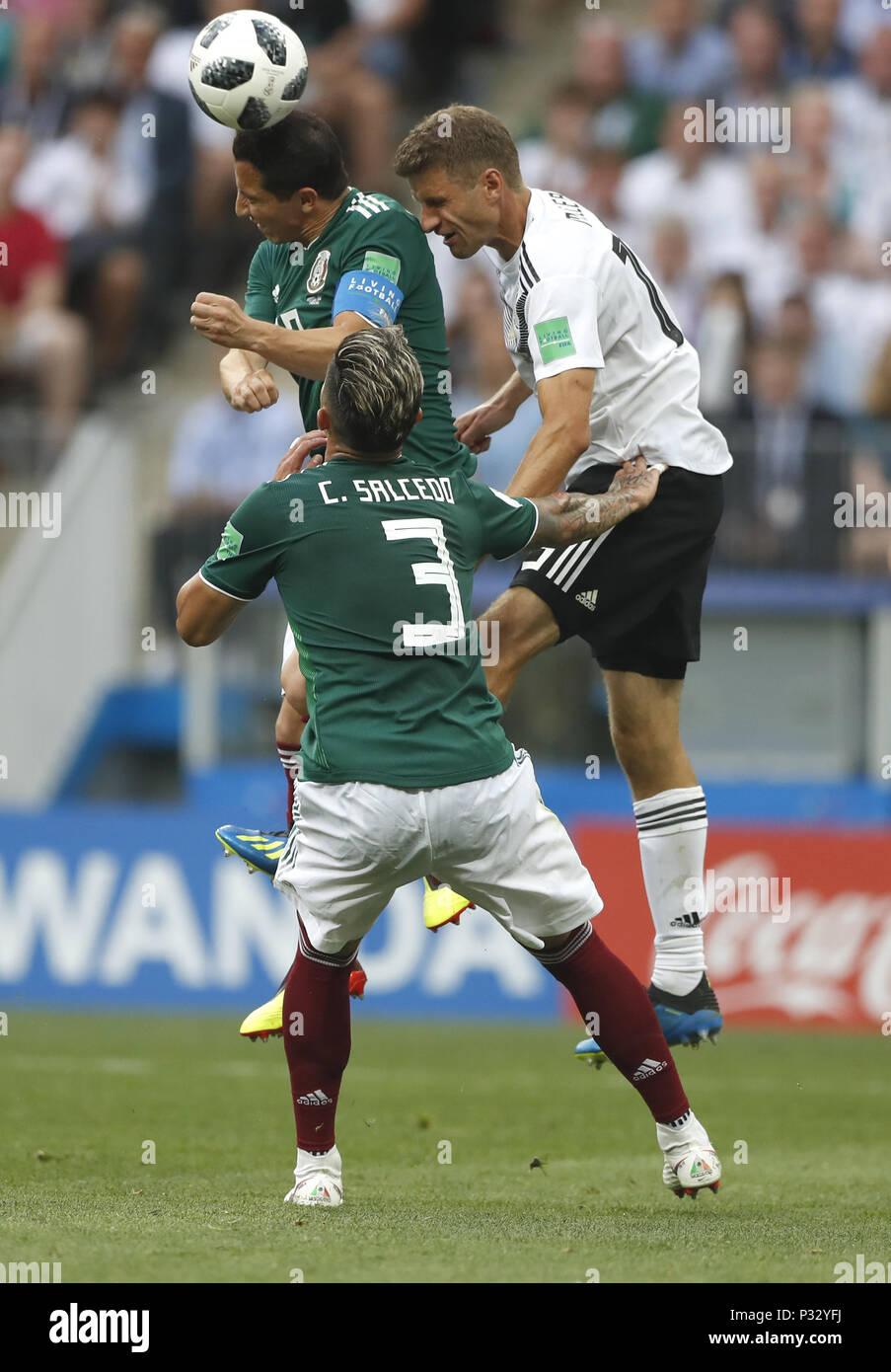 Moscow, Russia. 17th June, 2018. Thomas Mueller (R) of Germany competes for a header with Andres Guardado (L) of Mexico during a group F match between Germany and Mexico at the 2018 FIFA World Cup in Moscow, Russia, June 17, 2018. Credit: Cao Can/Xinhua/Alamy Live News Stock Photo