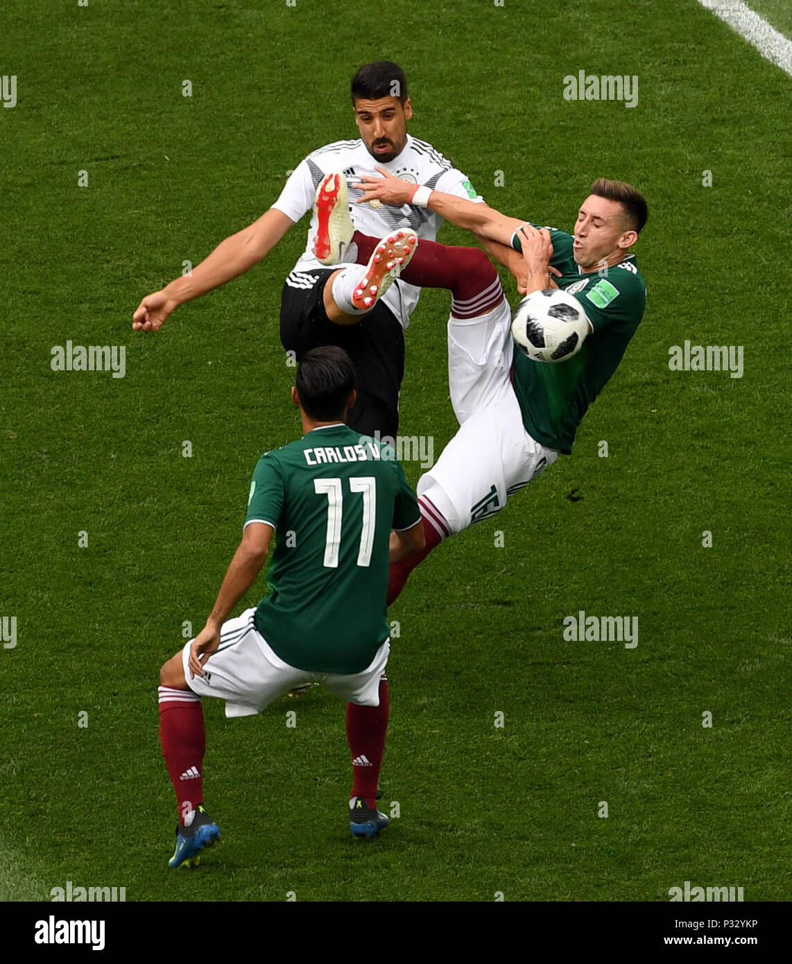 Moscow, Russia. 17th June, 2018. Sami Khedira (top) of Germany vies with Hector Herrera (R) of Mexico during a group F match between Germany and Mexico at the 2018 FIFA World Cup in Moscow, Russia, June 17, 2018. Credit: Wang Yuguo/Xinhua/Alamy Live News Stock Photo