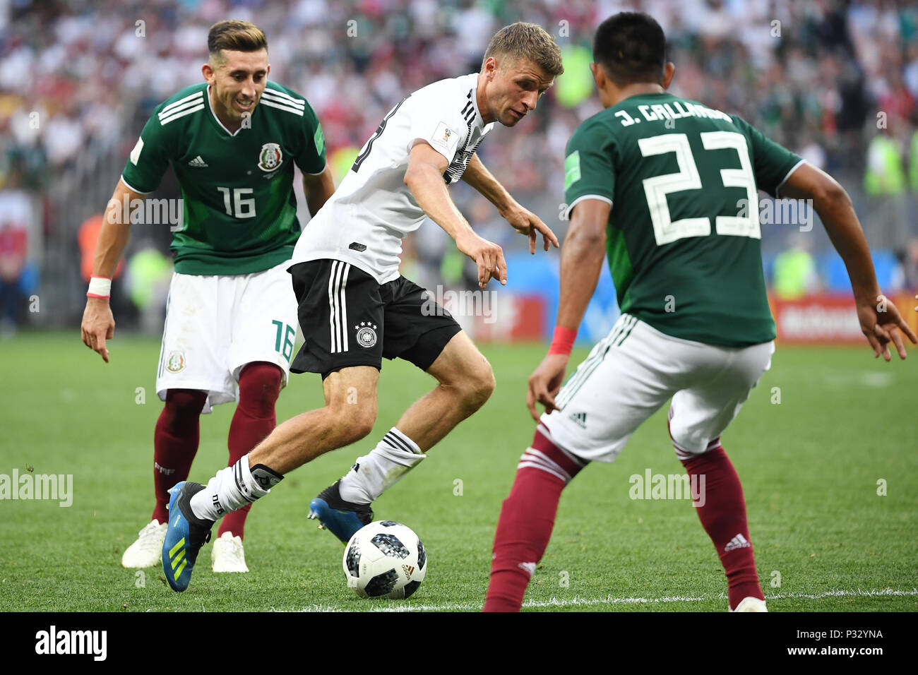 Moscow, Russia. 17th June, 2018. left to right Hector Herrera (Mexico), Thomas Mueller (Germany), Jesus Gallardo (Mexico). GES/Football/World Cup 2018 Russia: Germany - Mexico, 17.06.2018 GES/Soccer/Football/Worldcup 2018 Russia: Germany vs Mexico, Moscow, June 17, 2018 | usage worldwide Credit: dpa/Alamy Live News Stock Photo