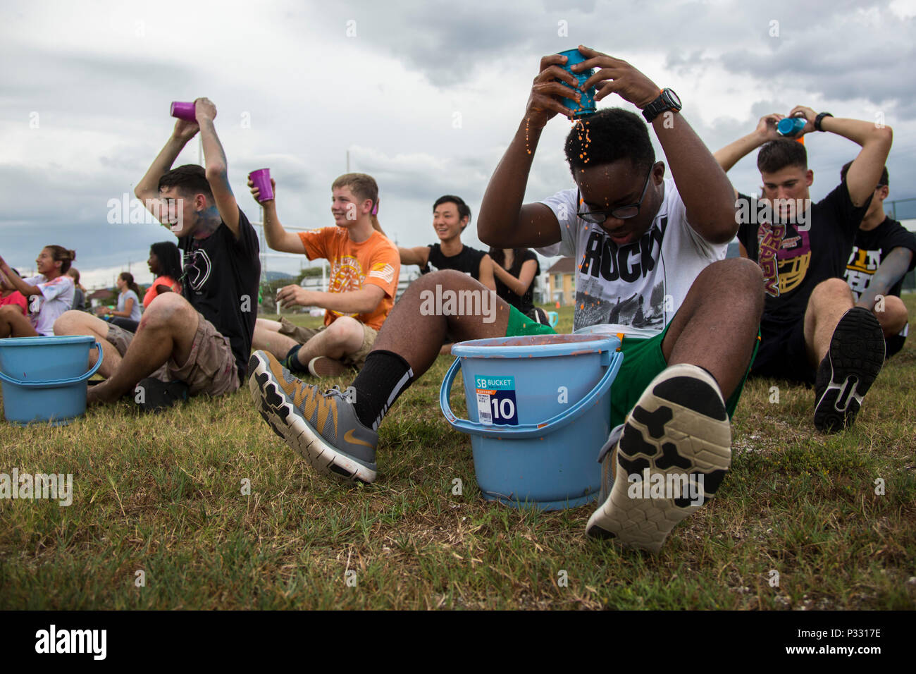 Students from Matthew C. Perry High School play pass the water during the  Back to School Bash at Marine Corps Air Station Iwakuni, Japan, Aug. 26,  2016. This school year will mark