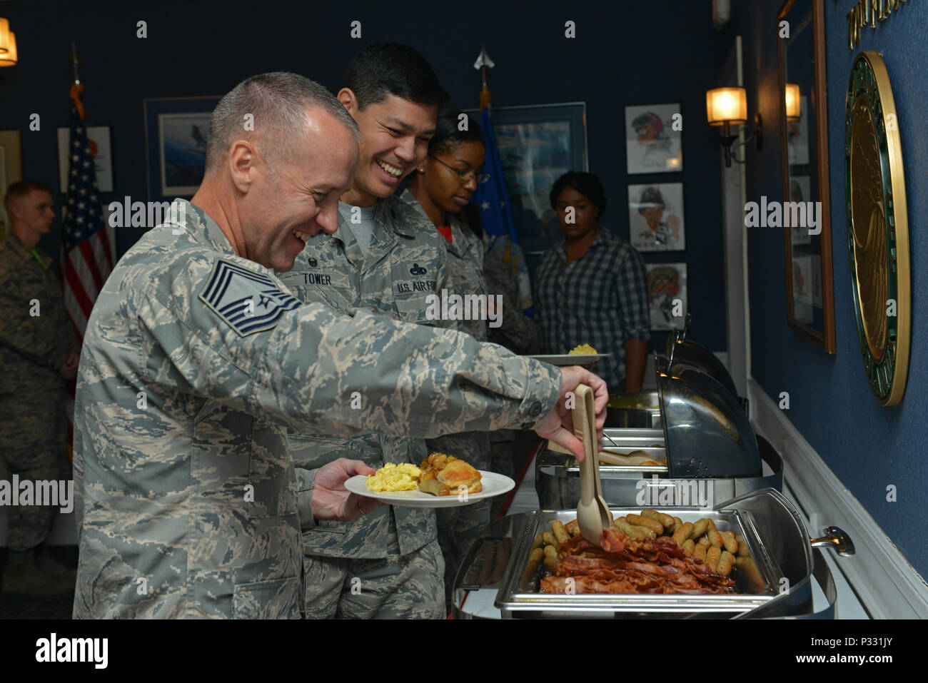 U.S. Air Force Chief Master Sgt. Dilbert Areford, 20th Equipment Maintenance Squadron superintendent, serves himself food during a Women’s Equality Day Breakfast at Shaw Air Force Base, S.C., Aug. 26, 2016. Women’s Equality Day was established in 1971 to commemorate the passing of the 19th Amendment, which granted women the right to vote. (U.S. Air Force photo by Airman 1st Class Destinee Sweeney) Stock Photo