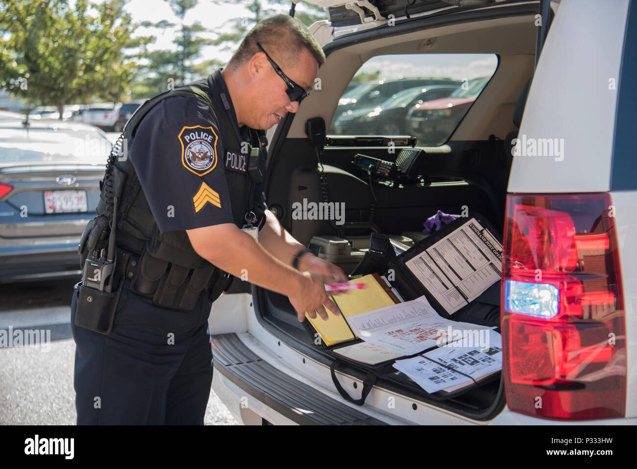 Police Officer Sgt. Jay Tu, watch commander for the Naval Security Force  assigned to Naval Support Activity Washington, established a command post  and begins reacting to the notional bomb threat during a