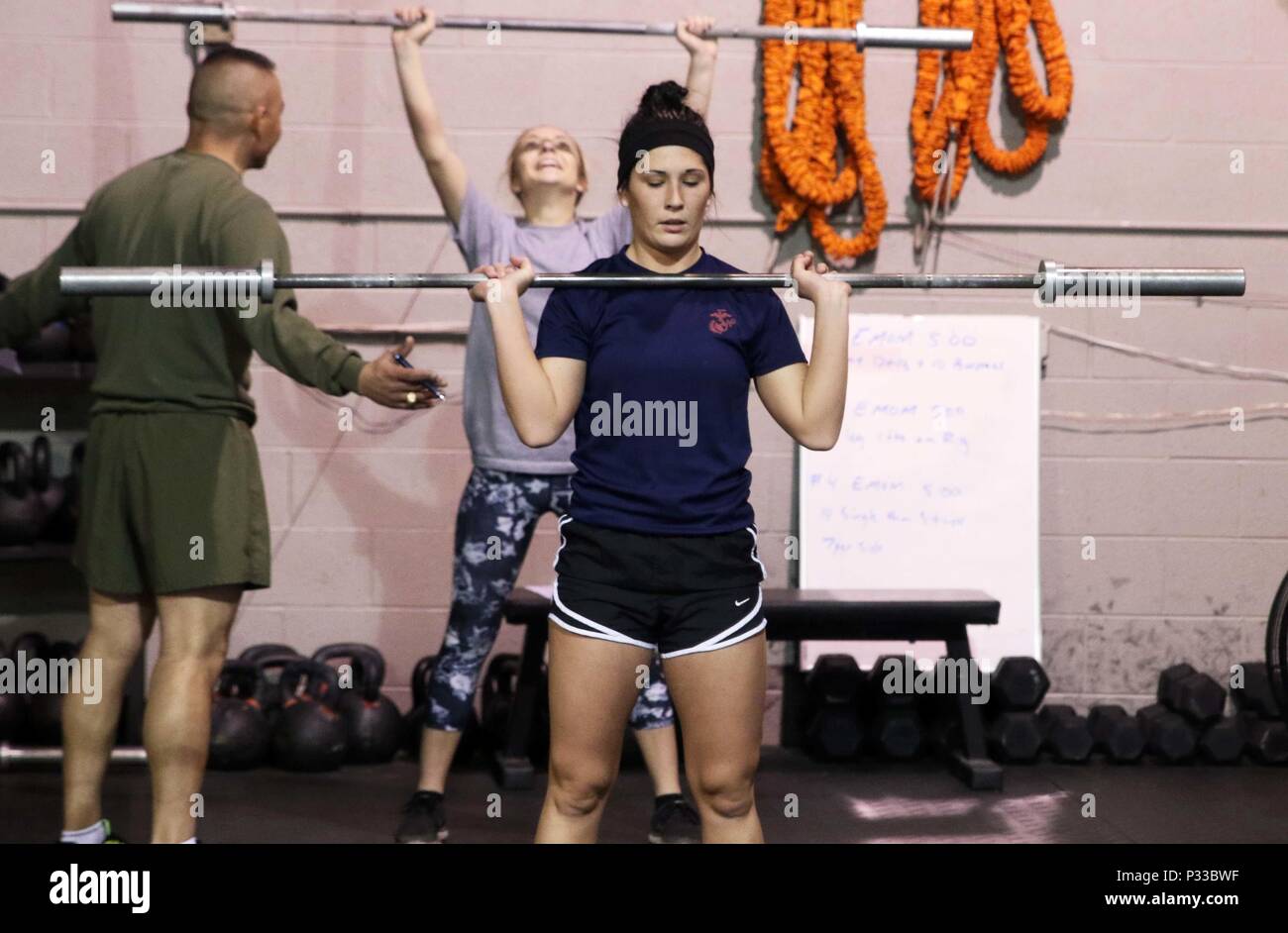 U.S. Marine Corps Poolee Maelym R. Russo performs push presses during a Marine Corps Recruiting Station Detroit’s all-hands female pool function December 10, 2016, in Troy, Michigan. Russo a native of Rockwood, Michigan, was recruited out of Recruiting Sub Station Wyandotte’s office and is slated to attend Marine Corps Recruit Depot Parris Island, South Carolina, in April 2017. (U.S. Marine Corps photo by Sgt. J. R. Heins/ Released) Stock Photo