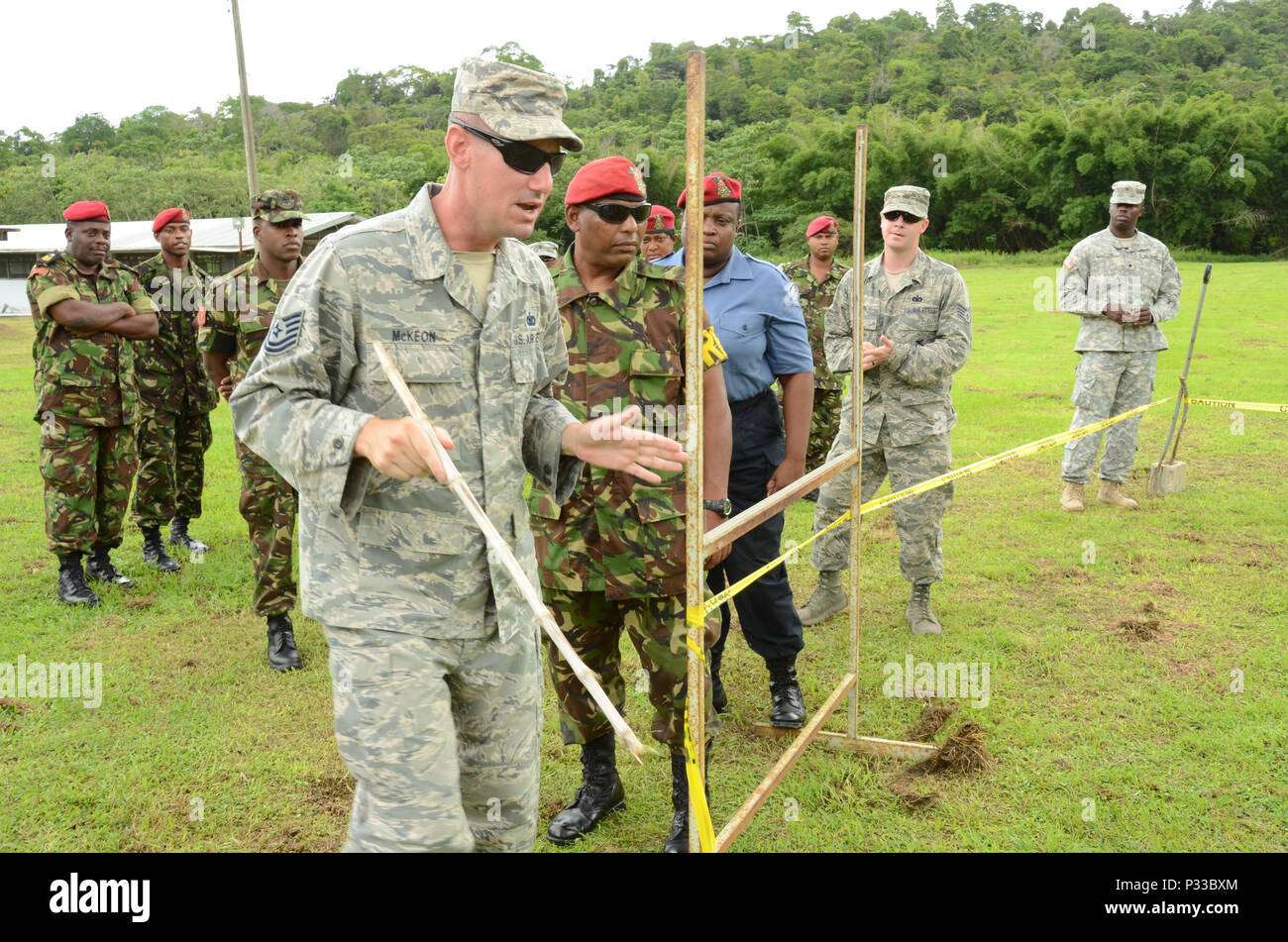 CHAGUARAMAS, Trinidad- Tech. Sgt. Michael Mckeon, fire team leader, 166th Security Forces Squadron, oversees training progression of room clearance procedures as participants of the Trinidad and Tobago Defence Force Reserves practice procedures on Aug. 10, 2016. (U.S. Air National Guard photo by Tech. Sgt. Gwendolyn Blakley/ Released). Stock Photo