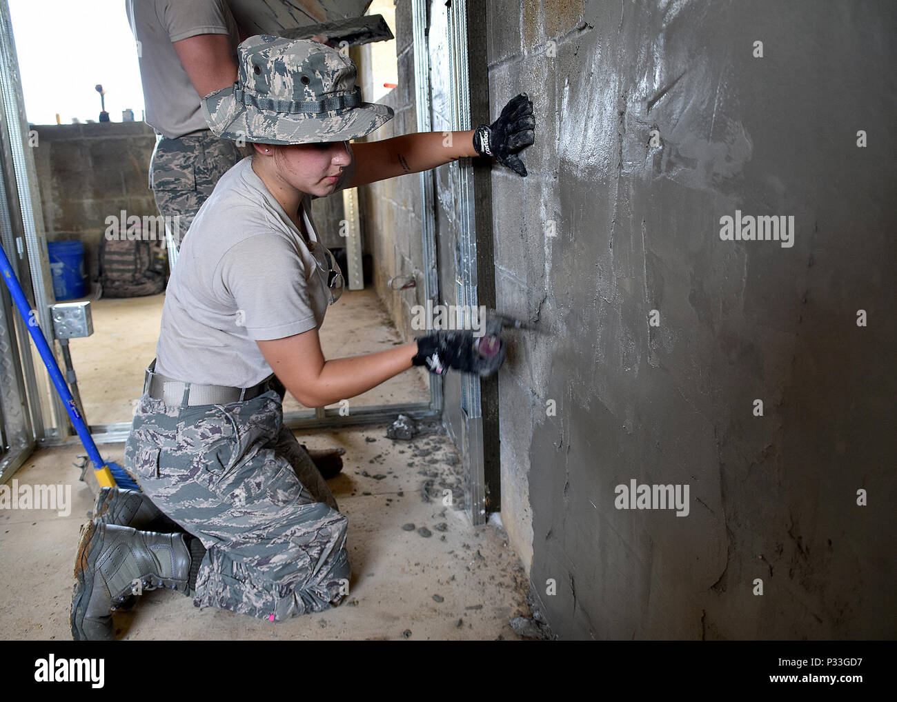Staff Sgt. Catherine Solano from the 143d Civil Engineering Squadron (CES),  Rhode Island Air National Guard provides cement skim coating to strengthen  walls for extreme weather conditions in Inarajan, Guam during an