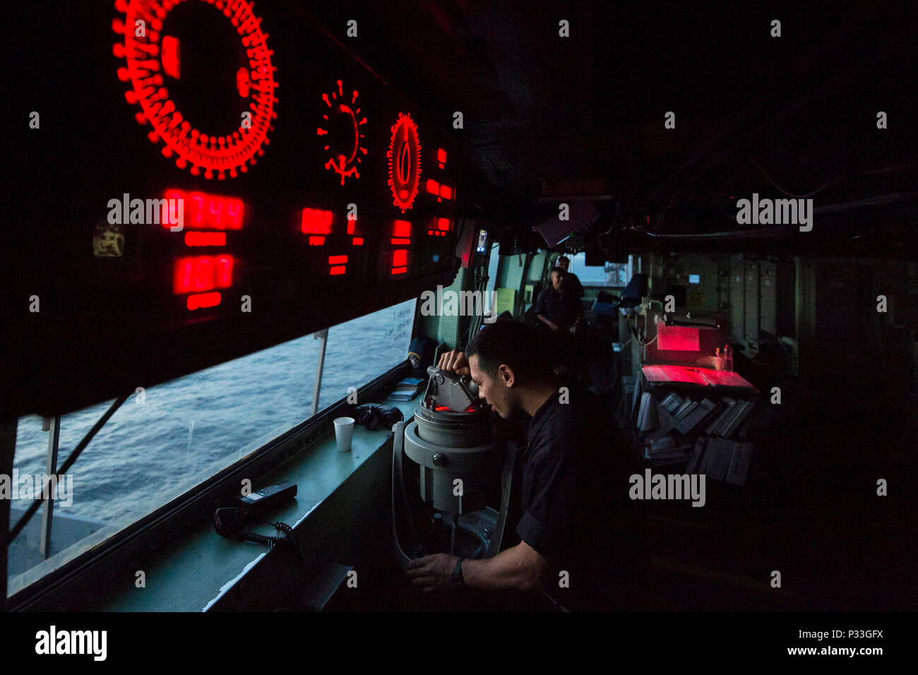 160830-N-DQ840-033 GULF OF ADEN (Aug. 30, 2016) Ensign Nathaniel Albia checks the relative bearing of surface contacts while standing watch aboard the amphibious transport dock ship USS San Antonio (LPD 17). San Antonio is deployed with the Wasp Amphibious Ready Group to support maritime security operations and theater security cooperation efforts in the U.S. 5th Fleet area of operations. (U.S. Navy photo by Mass Communication Specialist 2nd Class Adam Austin/Released) Stock Photo