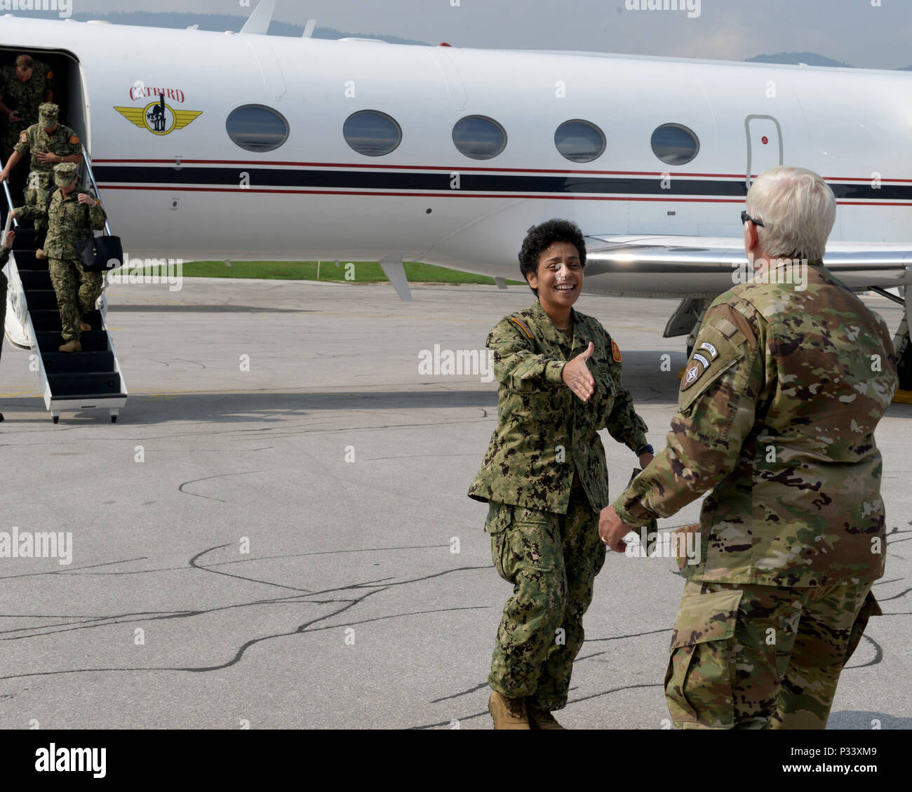 Brig. Gen. Giselle Wilz, NATO Headquarters Sarajevo commander, greets Adm. Michelle Howard, commander of Allied Joint Force Command, Naples, Italy, at the airport in Sarajevo, Bosnia and Herzegovina, Aug. 31, 2016. The admiral traveled to the capital city of BIH to discuss military and NATO operations in the Balkans area of responsibility. Stock Photo