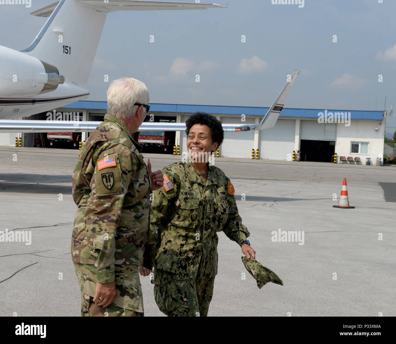 Brig. Gen. Giselle Wilz, NATO Headquarters Sarajevo commander, greets Adm. Michelle Howard, commander of Allied Joint Force Command, Naples, Italy, at the airport in Sarajevo, Bosnia and Herzegovina, Aug. 31, 2016. The admiral traveled to the capital city of BIH to discuss military and NATO operations in the Balkans area of responsibility. Stock Photo