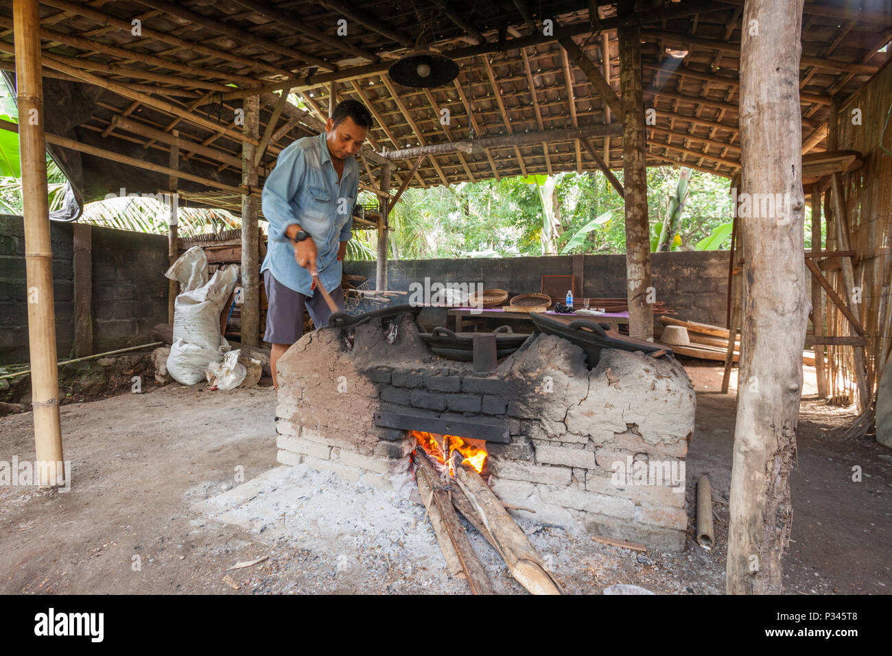 Master roasters manually roast coffee beans over a woodfired stove