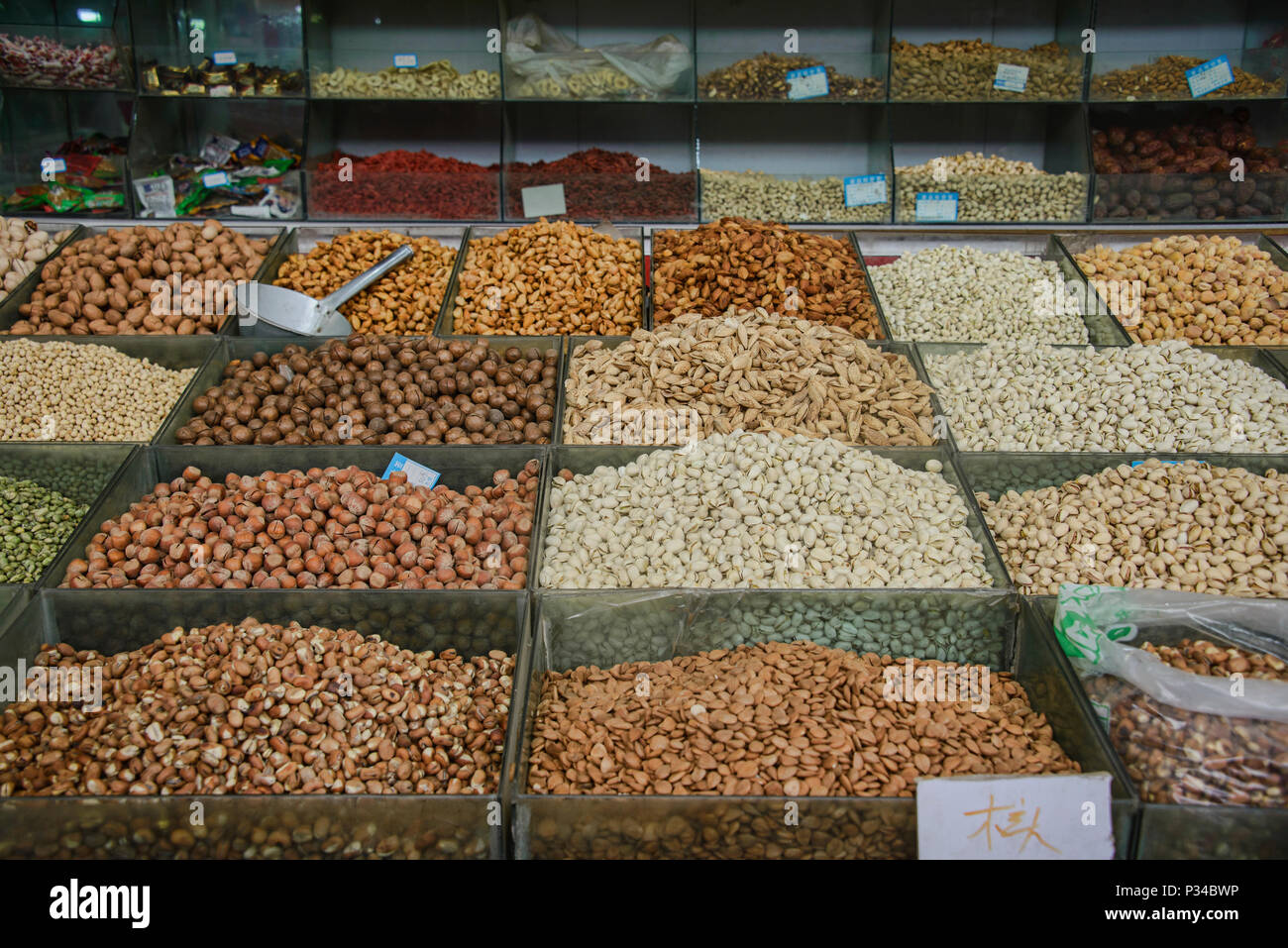 Raisins, nuts, and dried fruit for sale at the market in Dunhuang, Gansu, China Stock Photo
