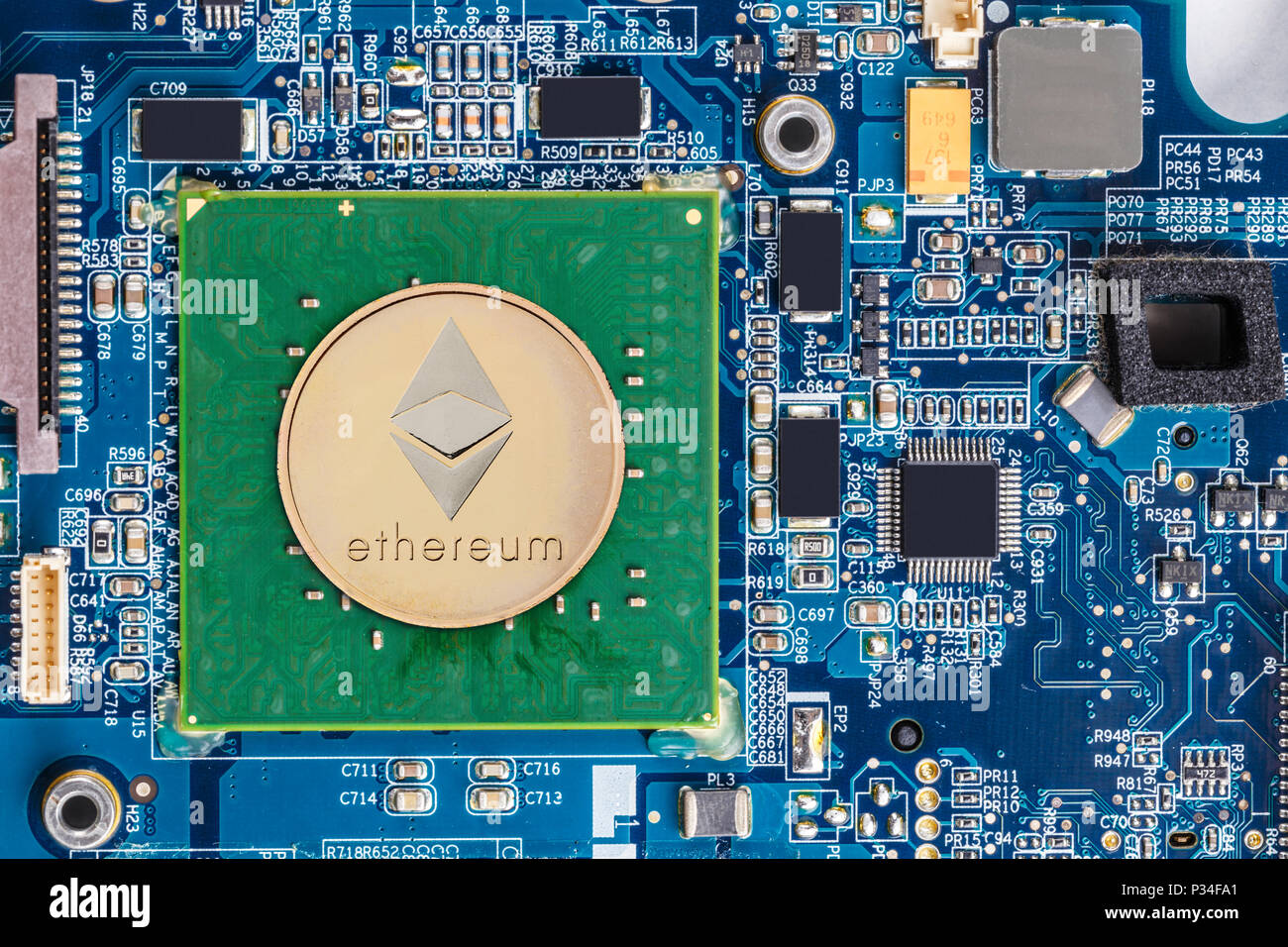 Golden ethereum and conputer motherboard chip on background Stock Photo