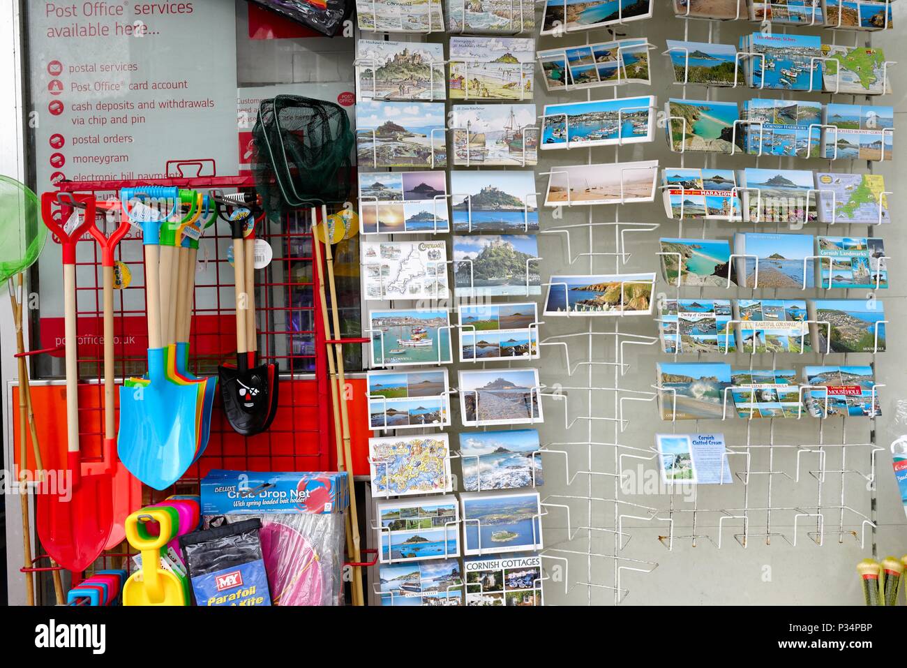 Close up of a rack of holiday postcards outside a seaside shop in Cornwall England UK Stock Photo