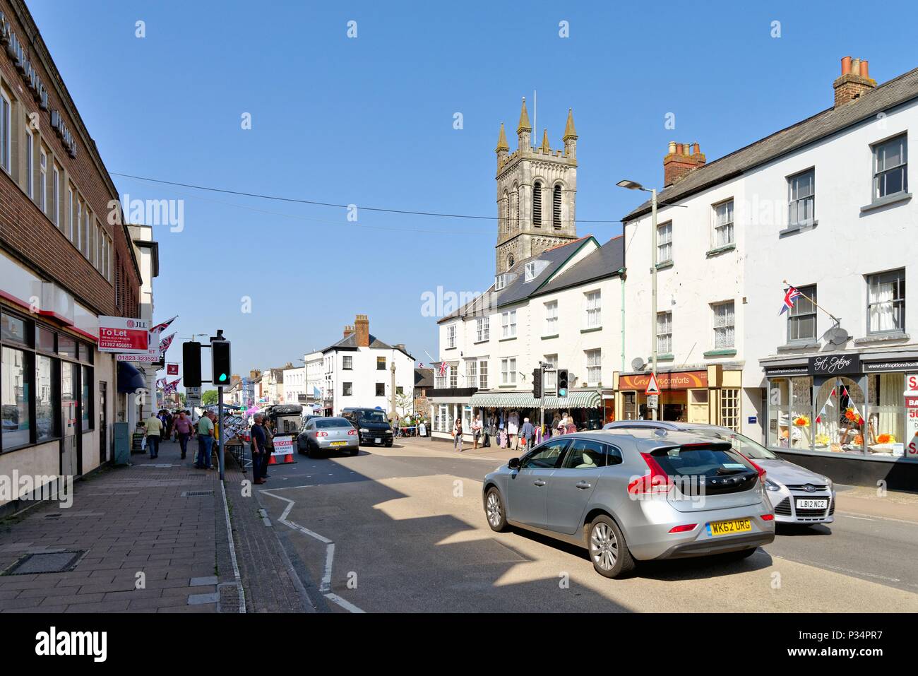 Busy Honiton High Street on a sunny summers day, East Devon England UK