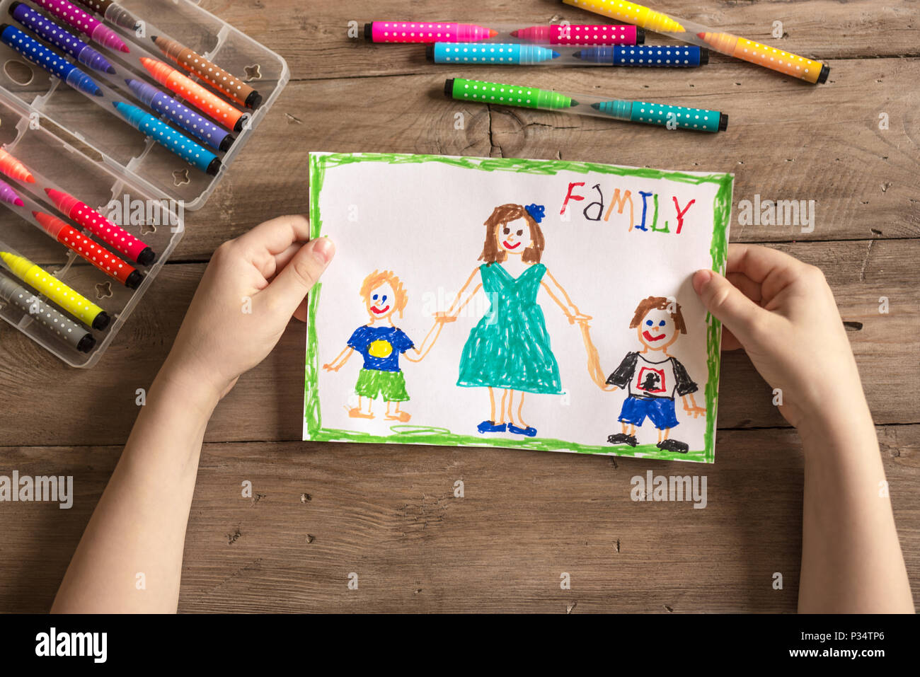 Children's drawing of family single mom and two sons. Incomplete family concept. Stock Photo
