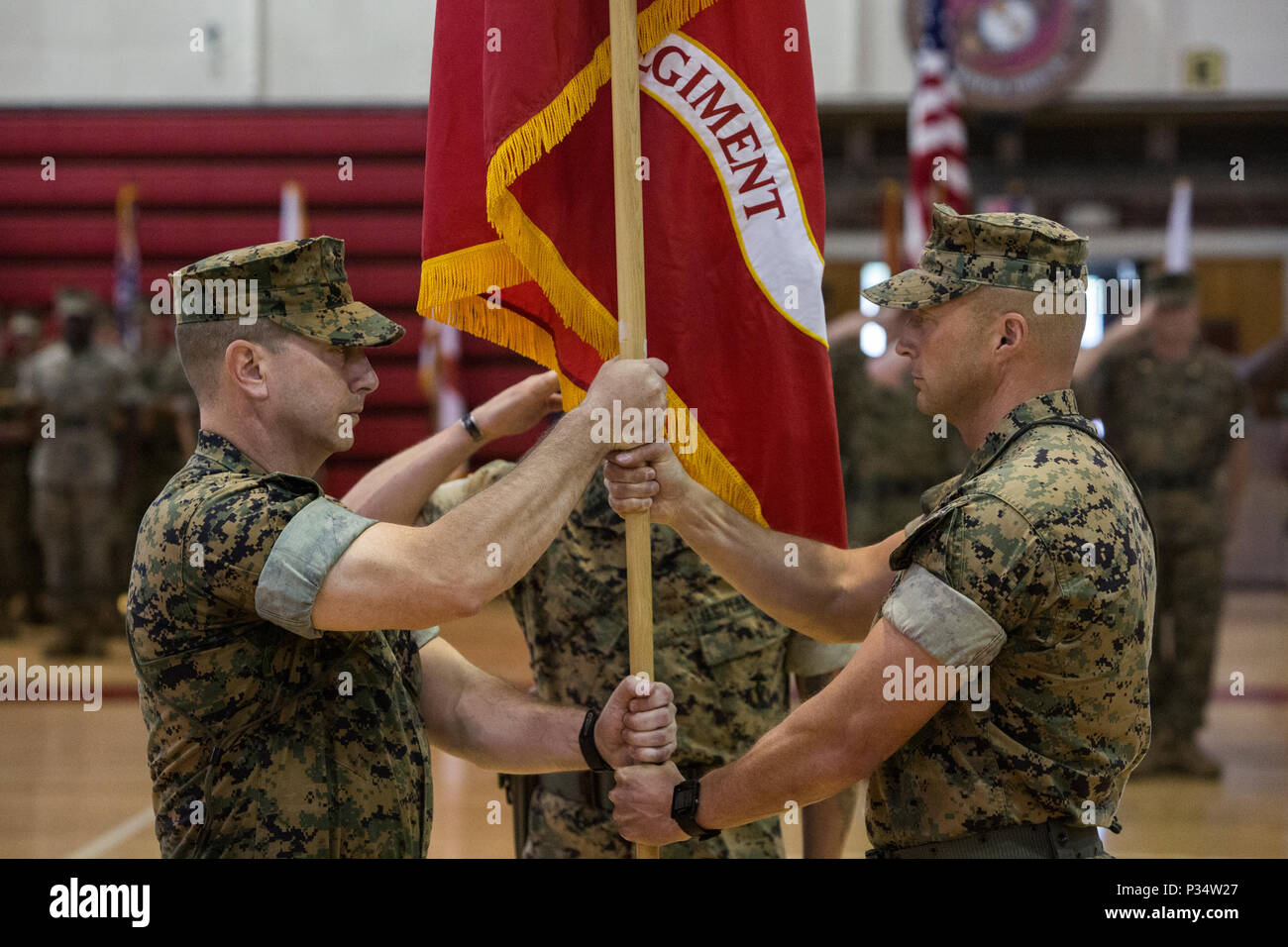 U.S. Marine Corps Col. Daniel T. Canfield Jr., left, the incoming commanding officer of 6th Marine Regiment, receives the unit colors from Col. Matthew S. Reid, right, the outgoing commanding officer of 6th Marine Regiment, 2nd Marine Division, during a change of command ceremony at Camp Lejeune, N.C., June 12, 2018. During the ceremony, Reid relinquished command of the unit to Canfield Jr. (U.S. Marine Corps photo by Pfc. Nathaniel Q. Hamilton) Stock Photo