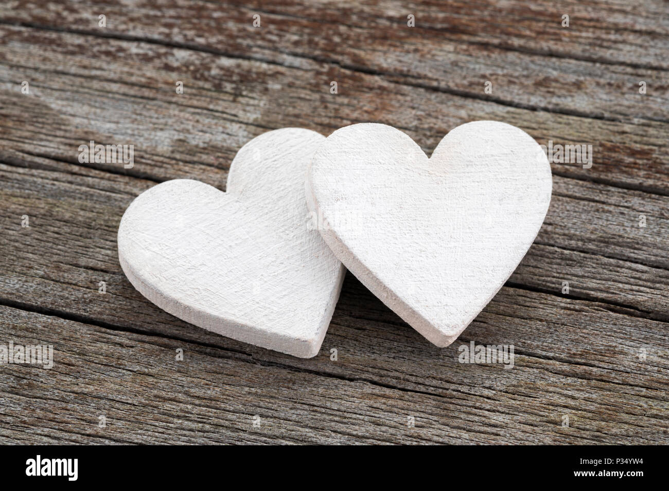 Two hearts on old wooden background Stock Photo
