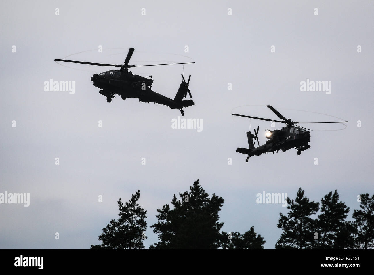 U.S. Army AH-64 Apache helicopters with Battle Group Poland, provide aerial support during a multinational training event for exercise Puma 2 with Battle Group Poland at Bemowo Piskie Training Area, Poland on June 14, 2018 as part of Saber Strike 18. This year's exercise, which runs from June 3-15, tests allies and partners from 19 countries on their ability work together to deter aggression in the region and improve each unit's ability to perform their designated mission. (U.S. Army photo by Spc. Hubert D. Delany III /22nd Mobile Public Affairs Detachment)  Stock Photo