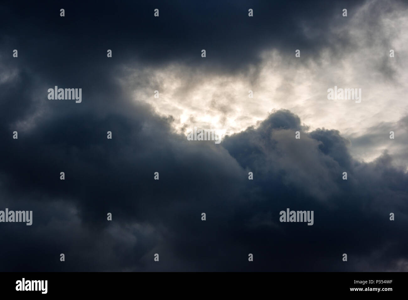 dark dense gloomy dramatic thundercloud on summer day Stock Photo
