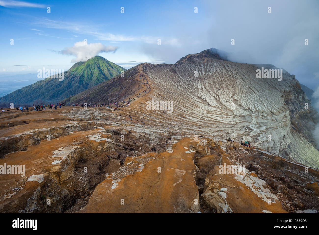 Visitors walk along the rim of the Ijen volcano crater on Java, Indonesia Stock Photo