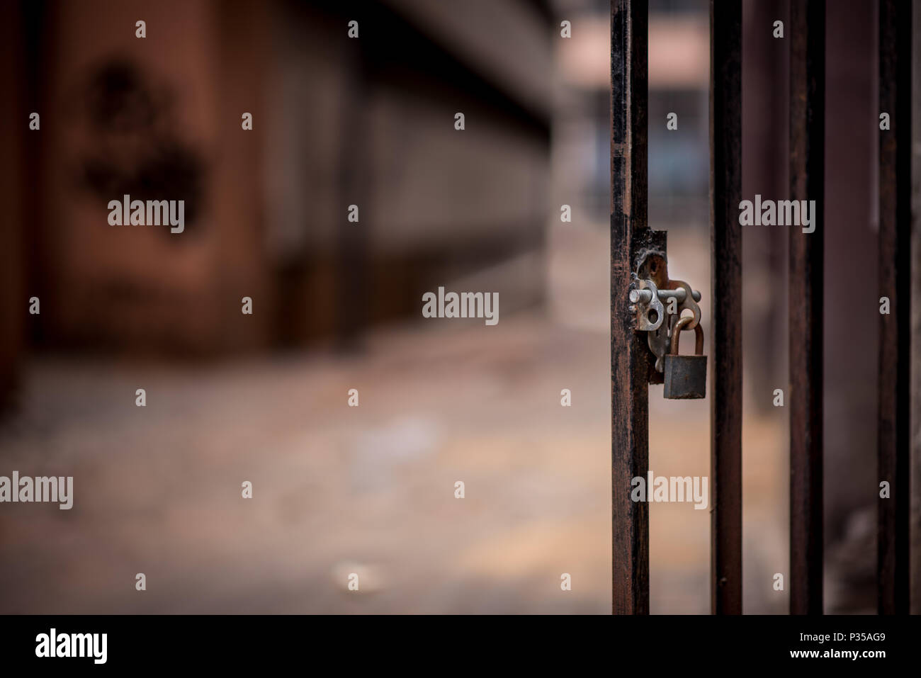 A closeup of a metal door with a padlock in a Johanneburg inner city alley way Stock Photo
